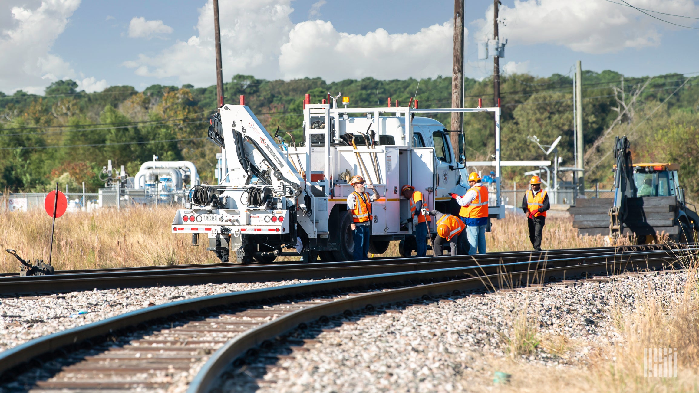 Workers inspecting railroad track.