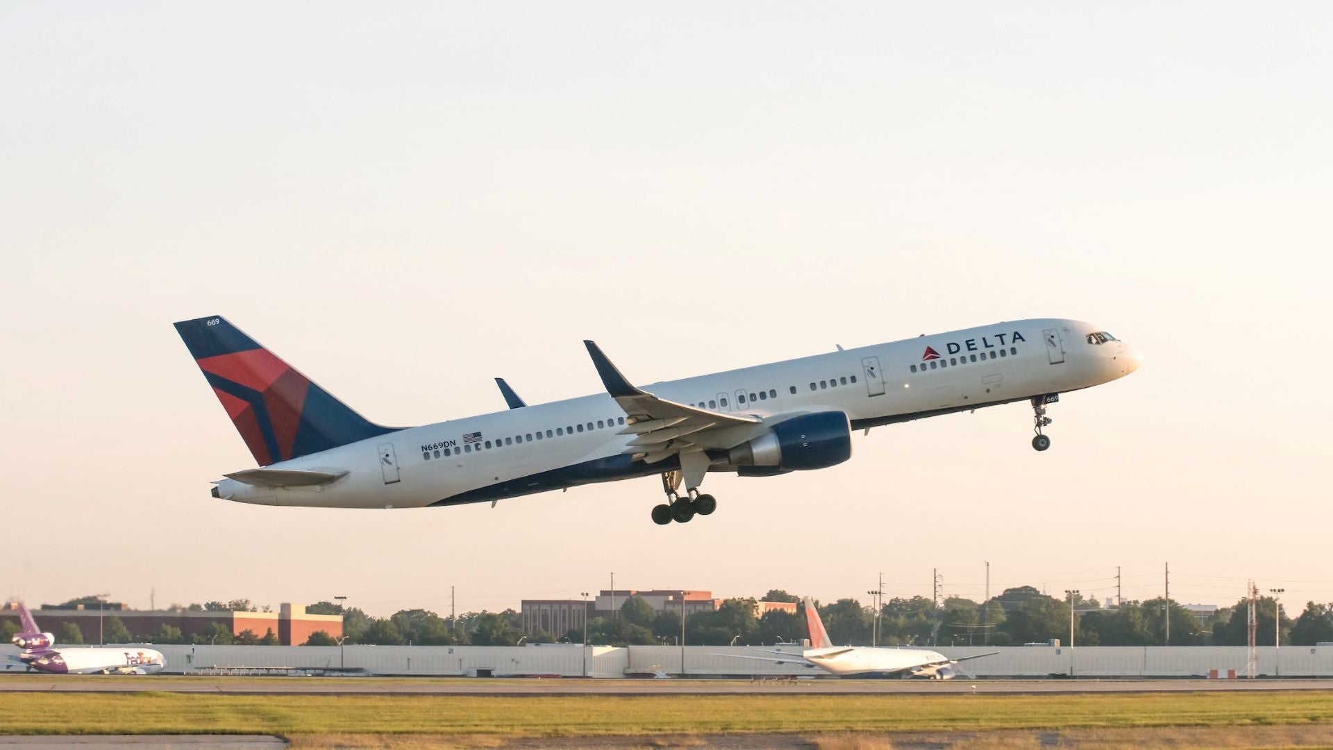 A white, with blue tail, Delta jet comes in for landing with wheels down. Delta Air Lines' took a loss in the first quarter, but cargo revenue was strong and profits are expected soon.