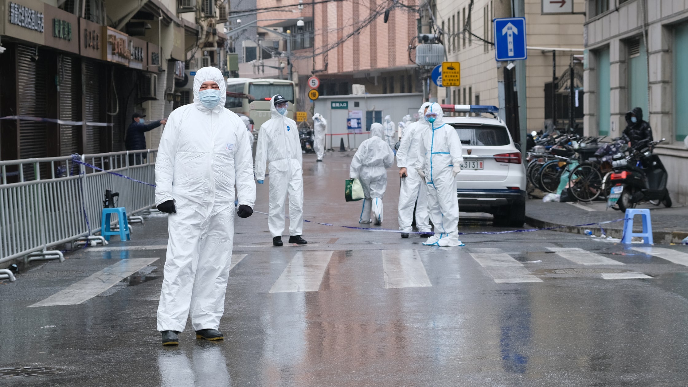 Medical staff in white hazmat suits on the streets of Shanghai. A mass quarantine has made it very difficult for trucks to get through the city.