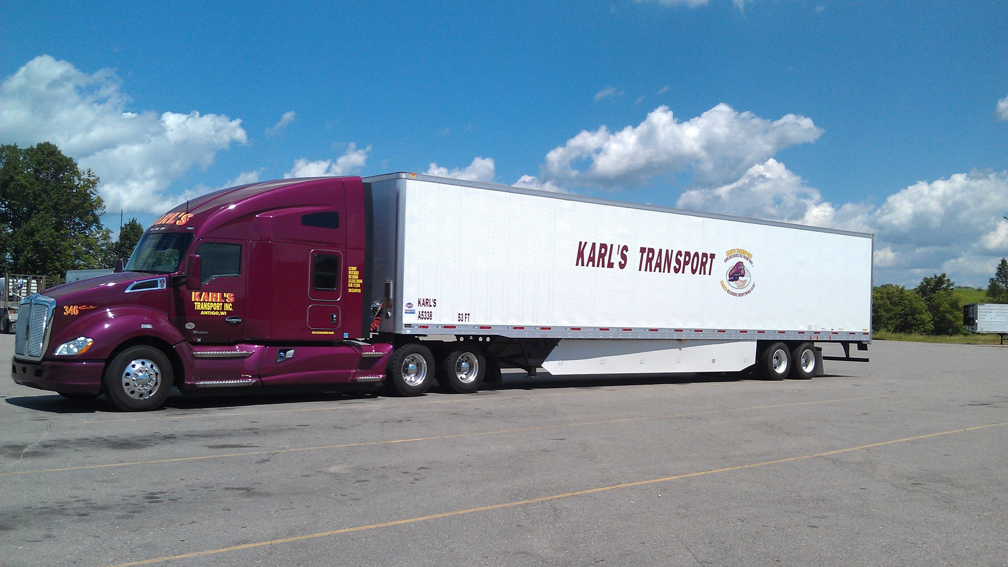 A red cab white trailer Karl's Transport truck.