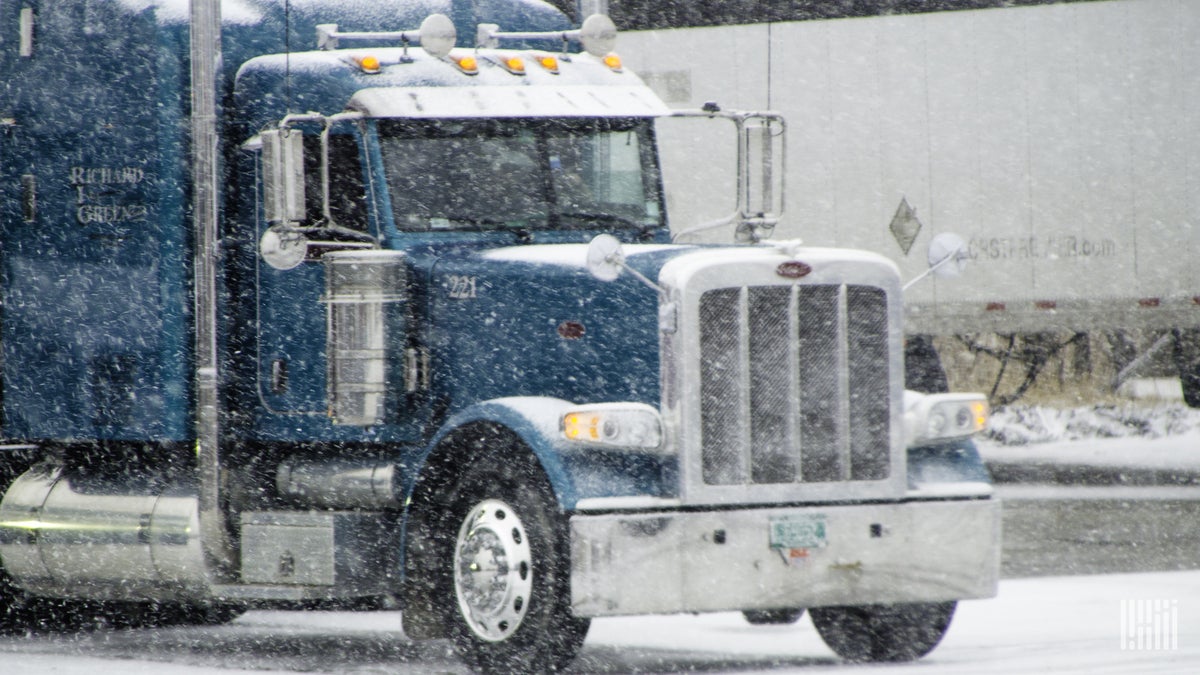 Tractor-trailer in heavy snow.