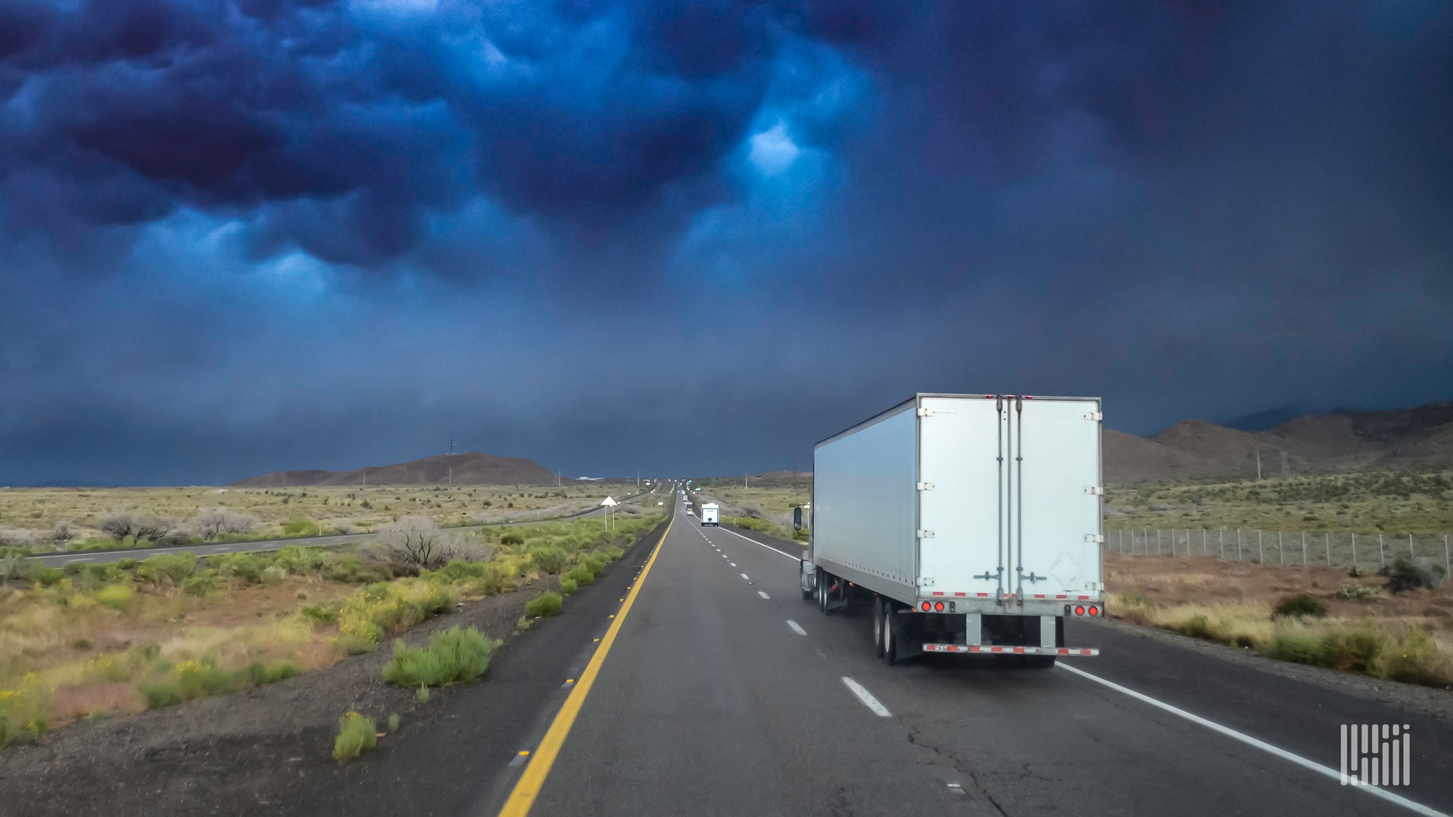 Truck heading toward a thunderstorm.