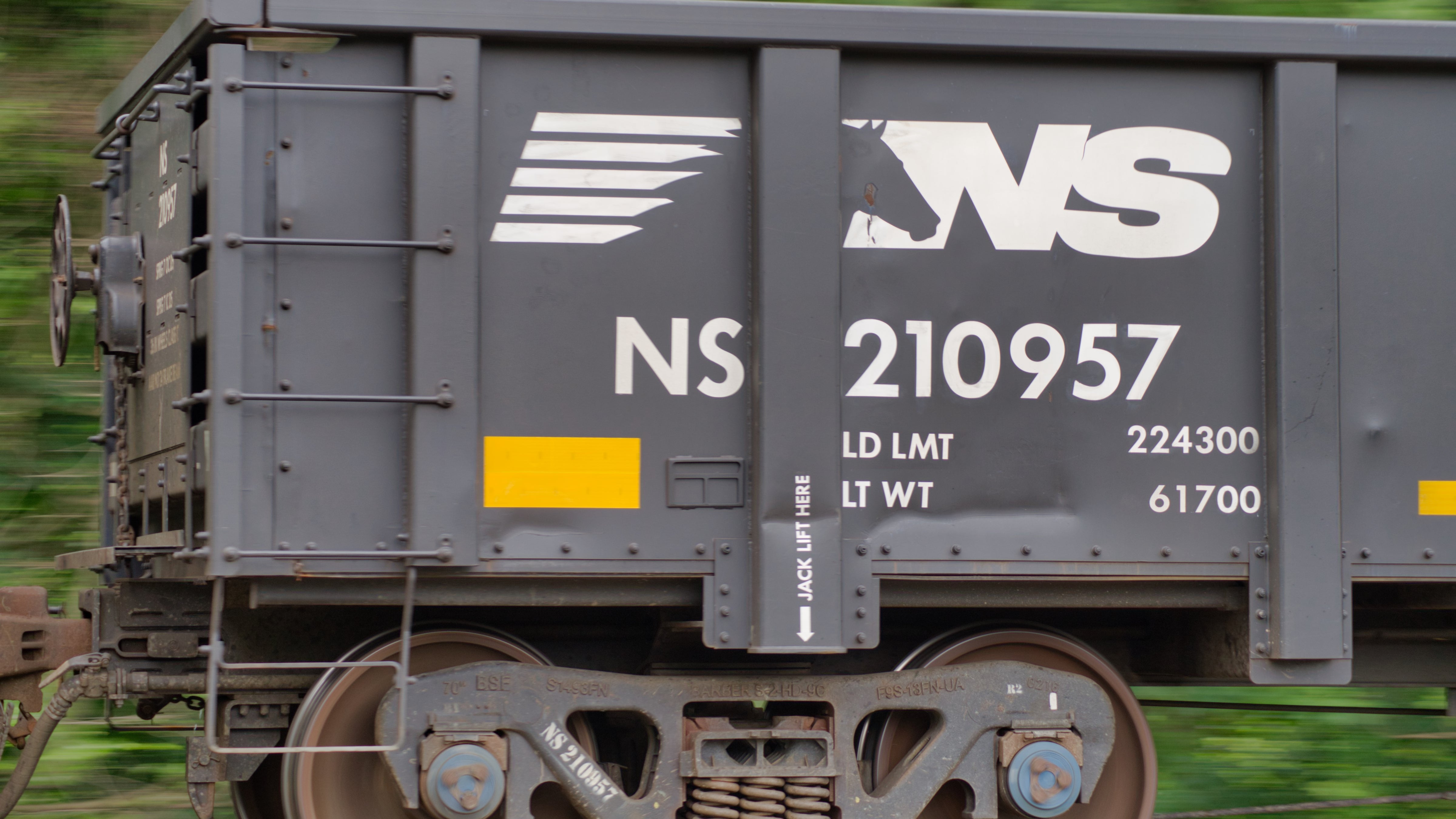 A close-up photograph of a railcar with the NS logo on it.