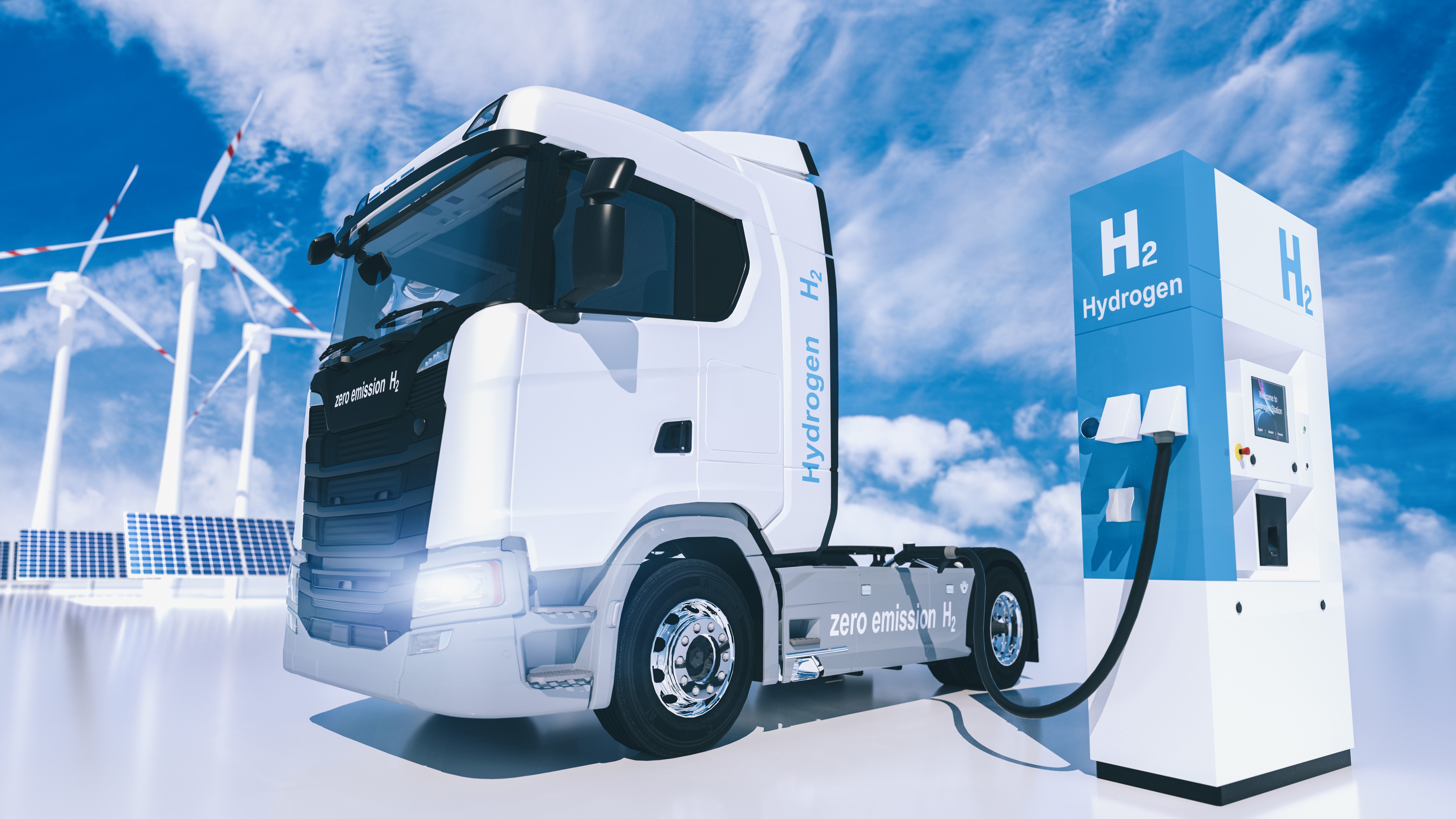 A semi truck being fueled with green hydrogen produced from wind energy.