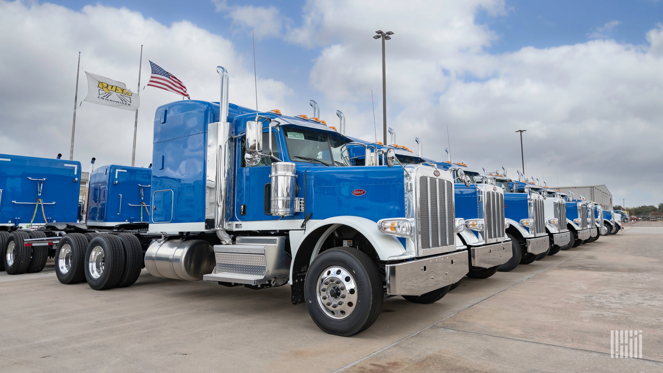 Row of blue Peterbilt Class 8 trucks at dealership