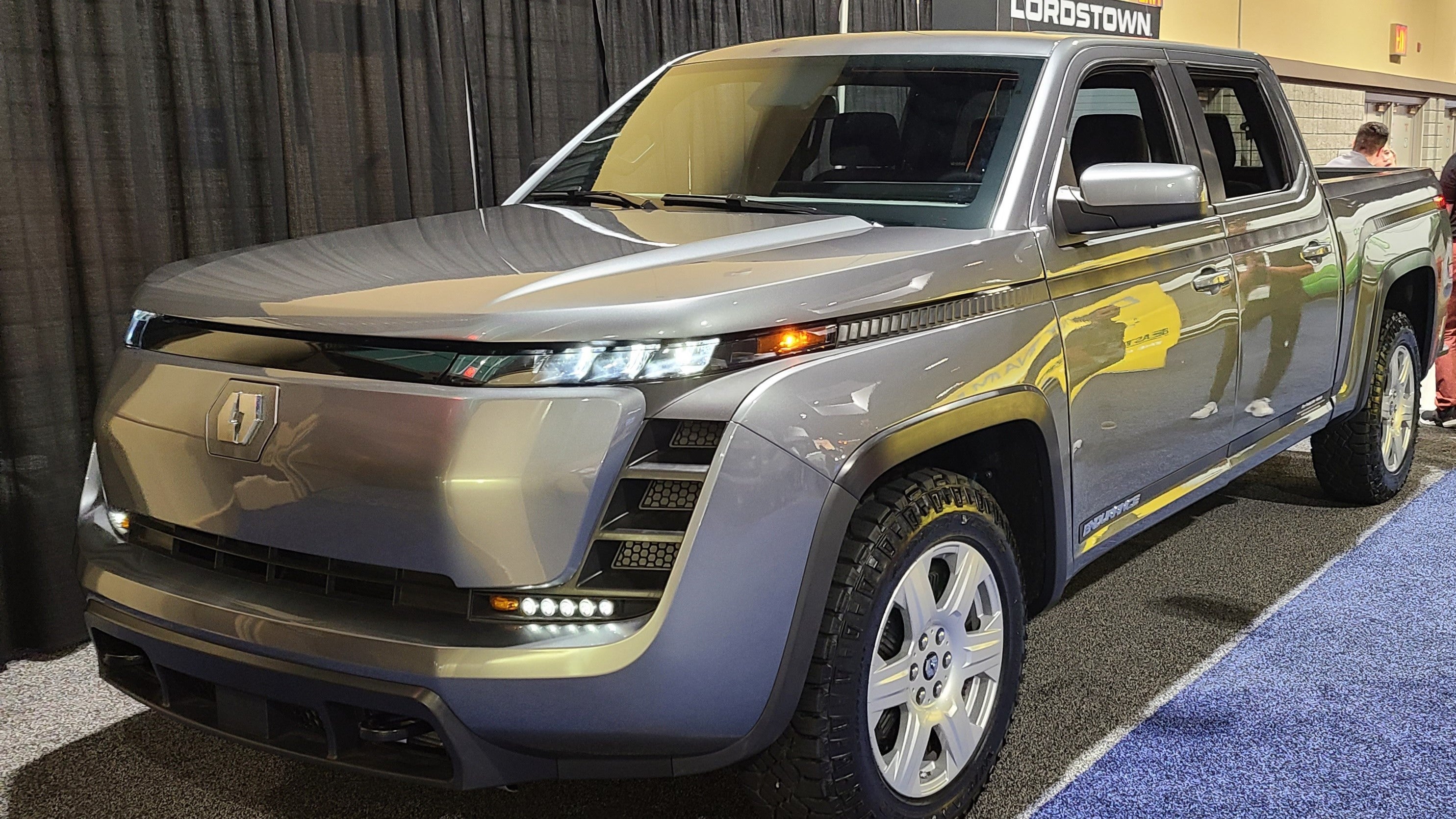 Front 3/4 view of silver Lordstown Endurance electric pickup truck on display at the Advanced Clean Technology Expo in Long Beach, California.