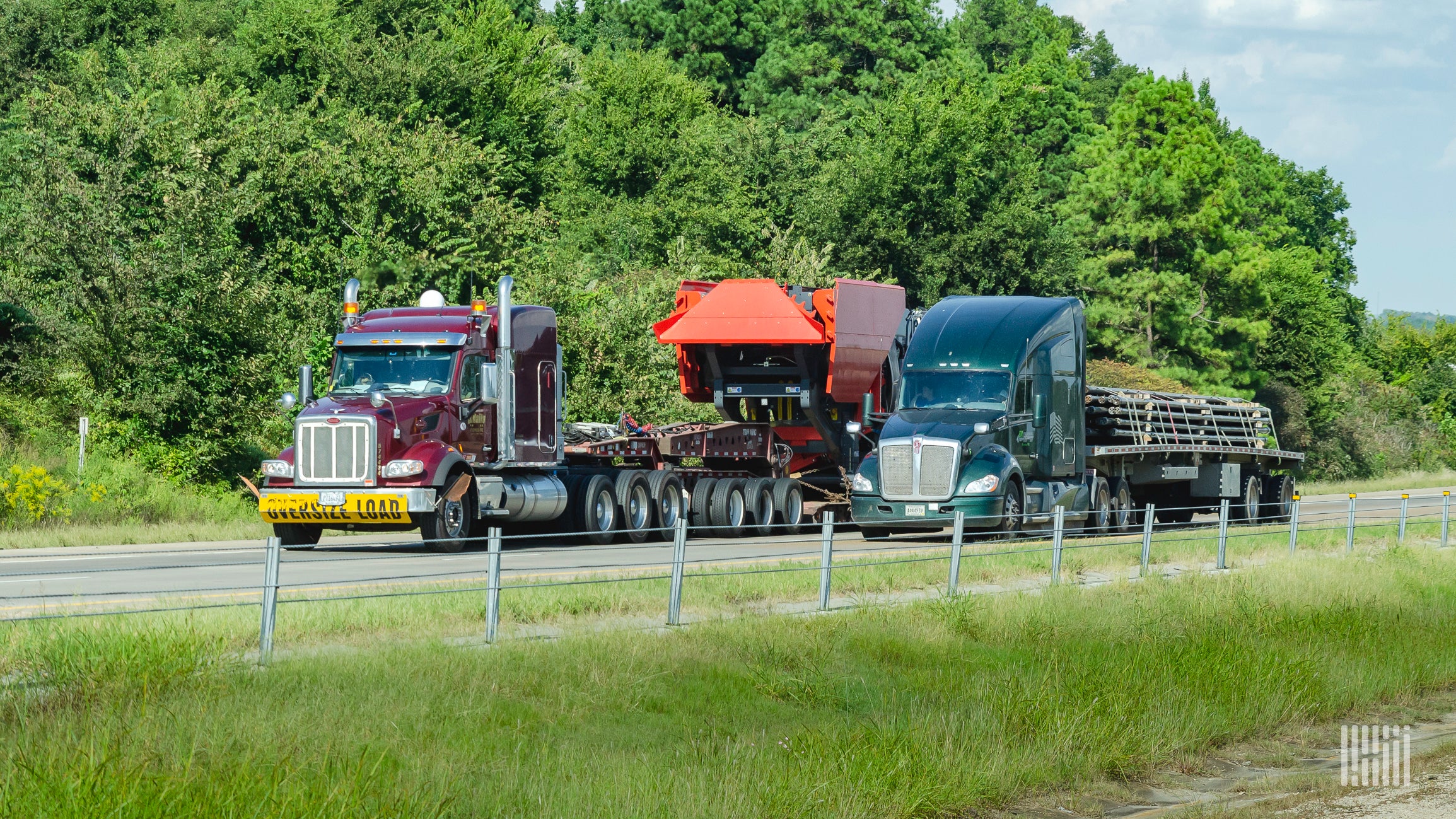 A truck hauling an open deck trailer