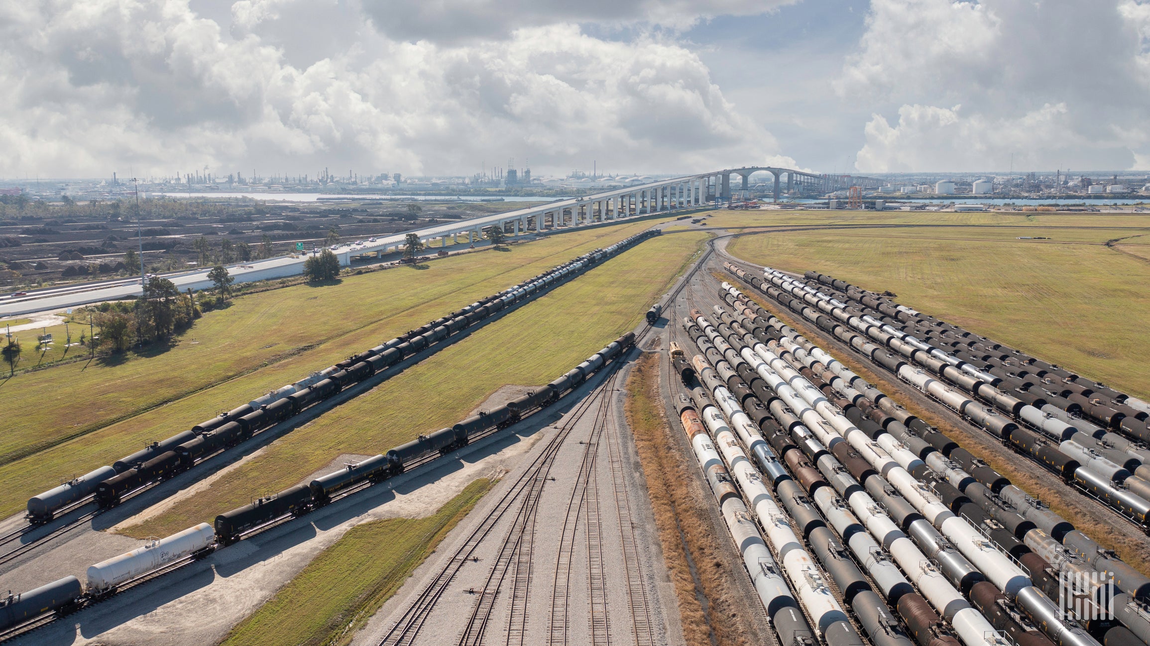 Rows of tanker cars parked at a rail yard.