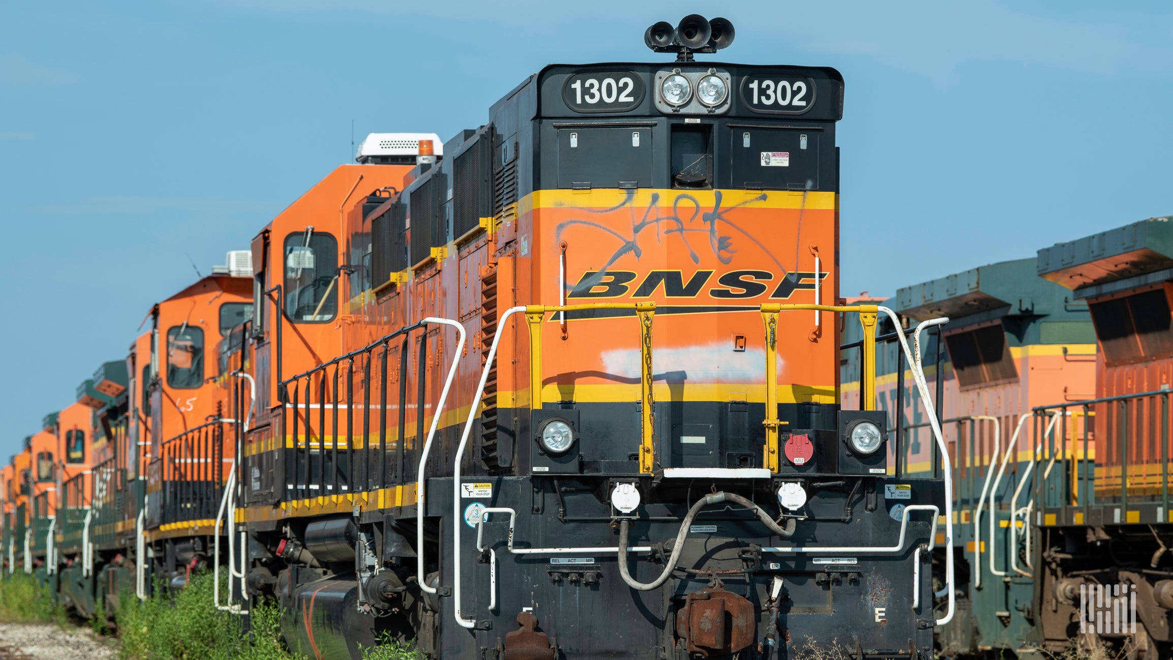 BNSF locomotives lined up in a rail yard.