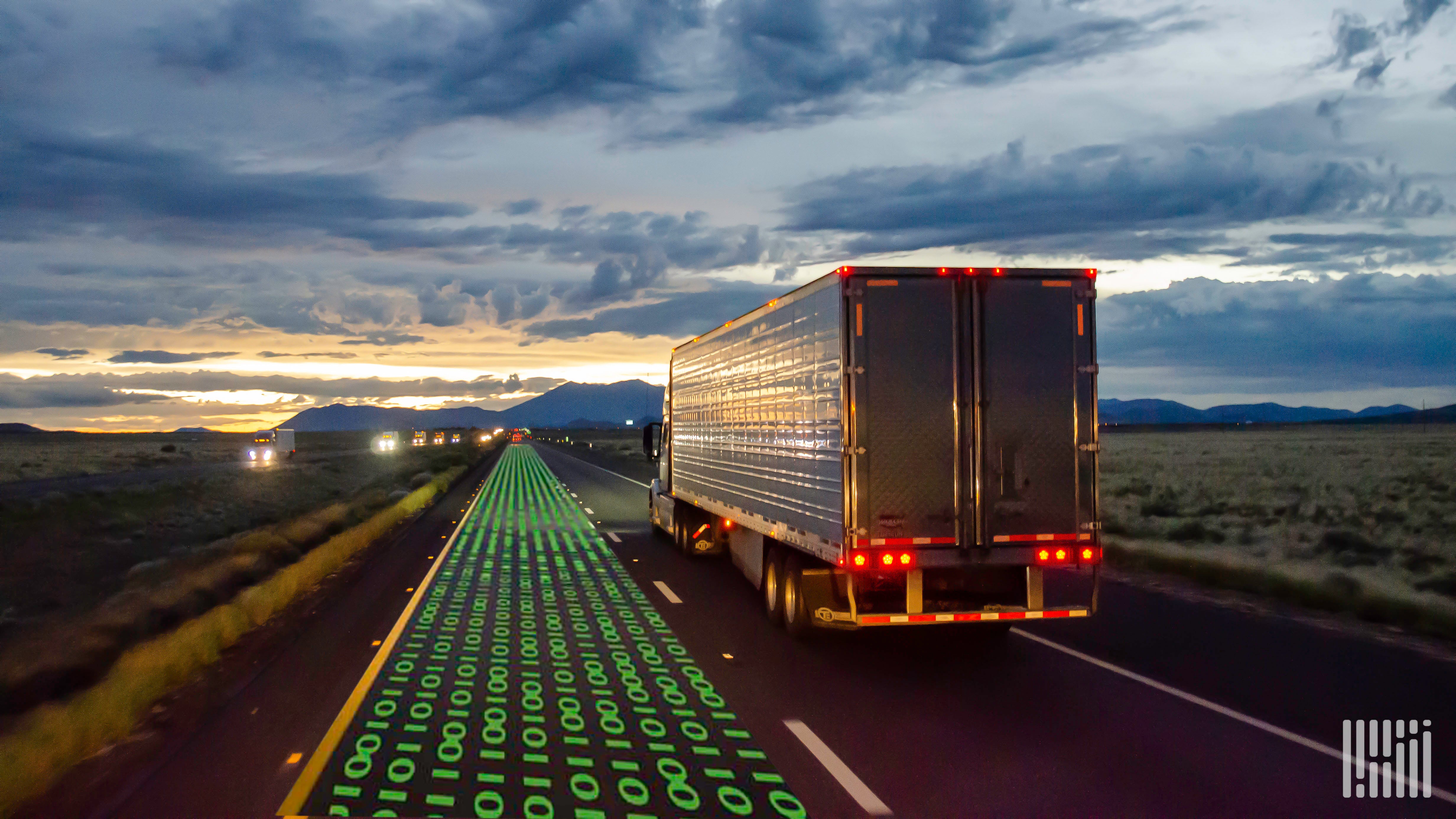 A trucking driving alongside ones and zeros representing data