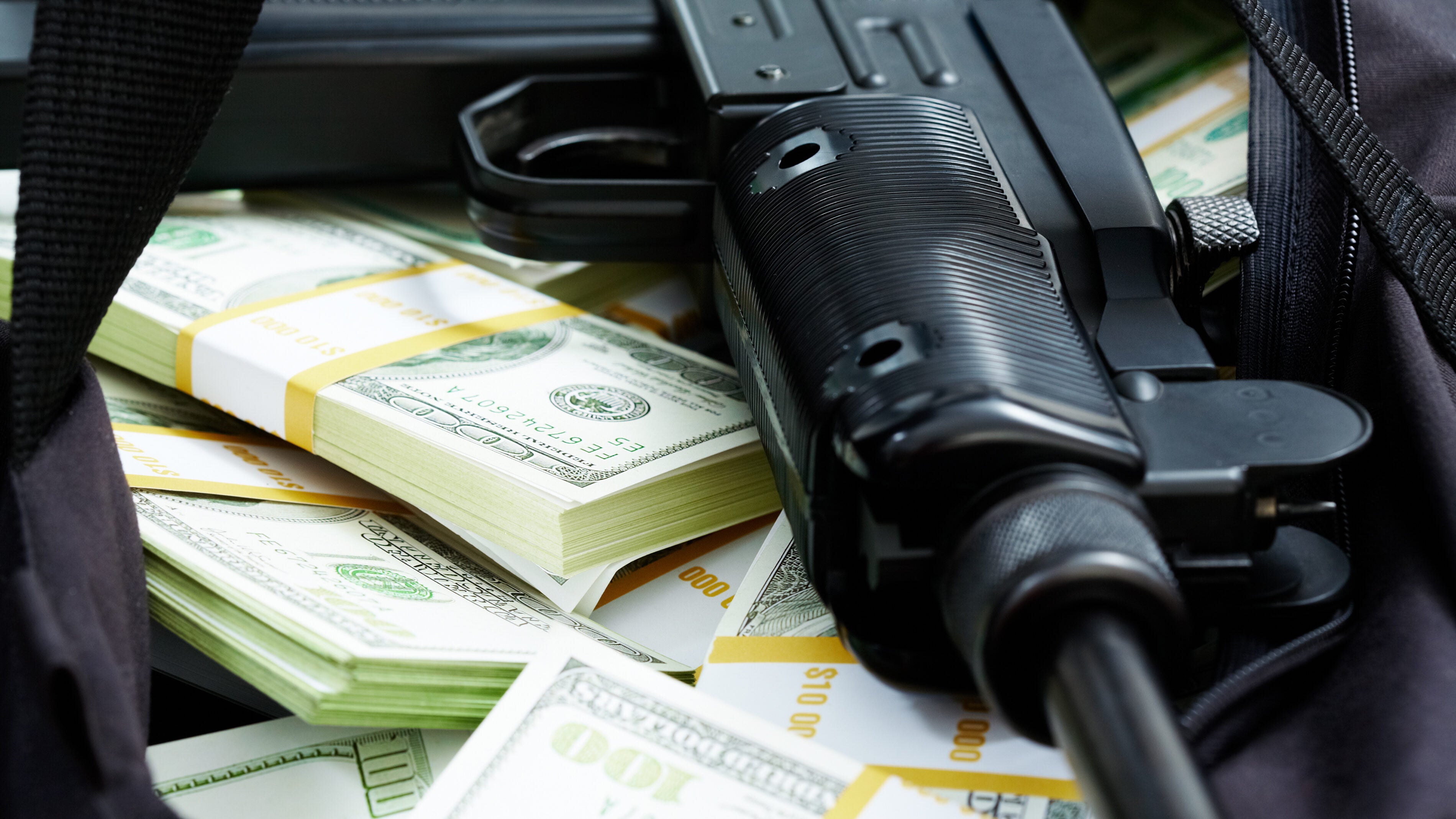 Machine gun with banded packs of U.S. currency.