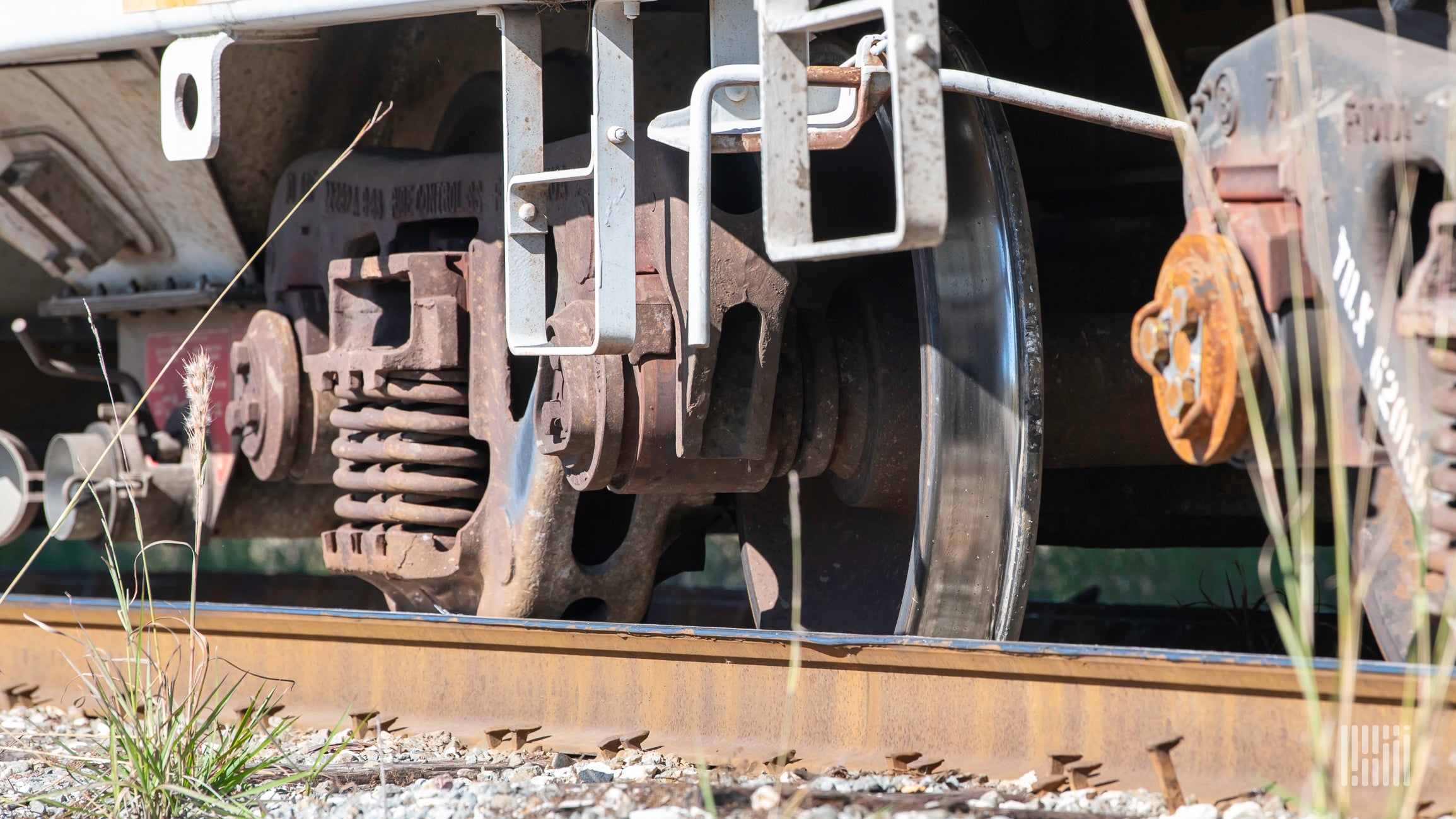 A close-up photo of railcar wheels on a rail track.