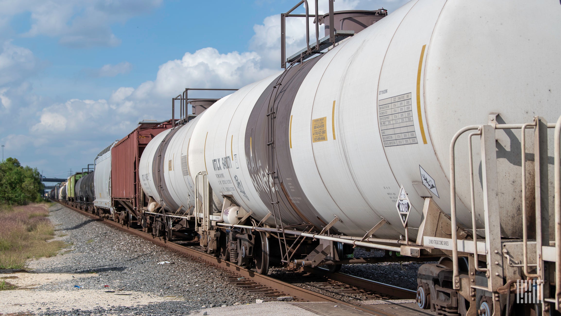 Tank cars and boxcar cars forming a train.