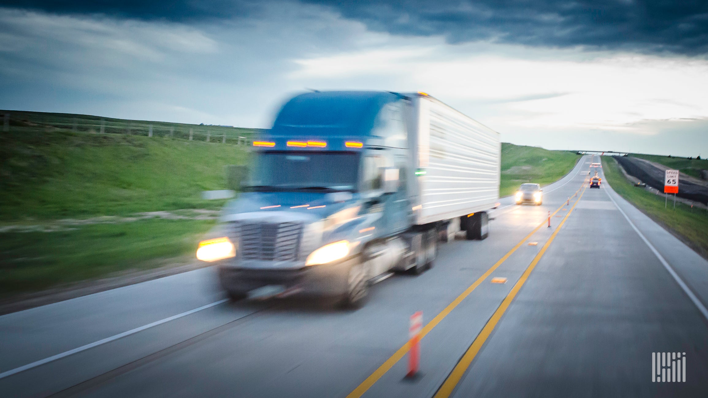 Truck in motion on the highway to illustrate a speed limit for heavy trucks.