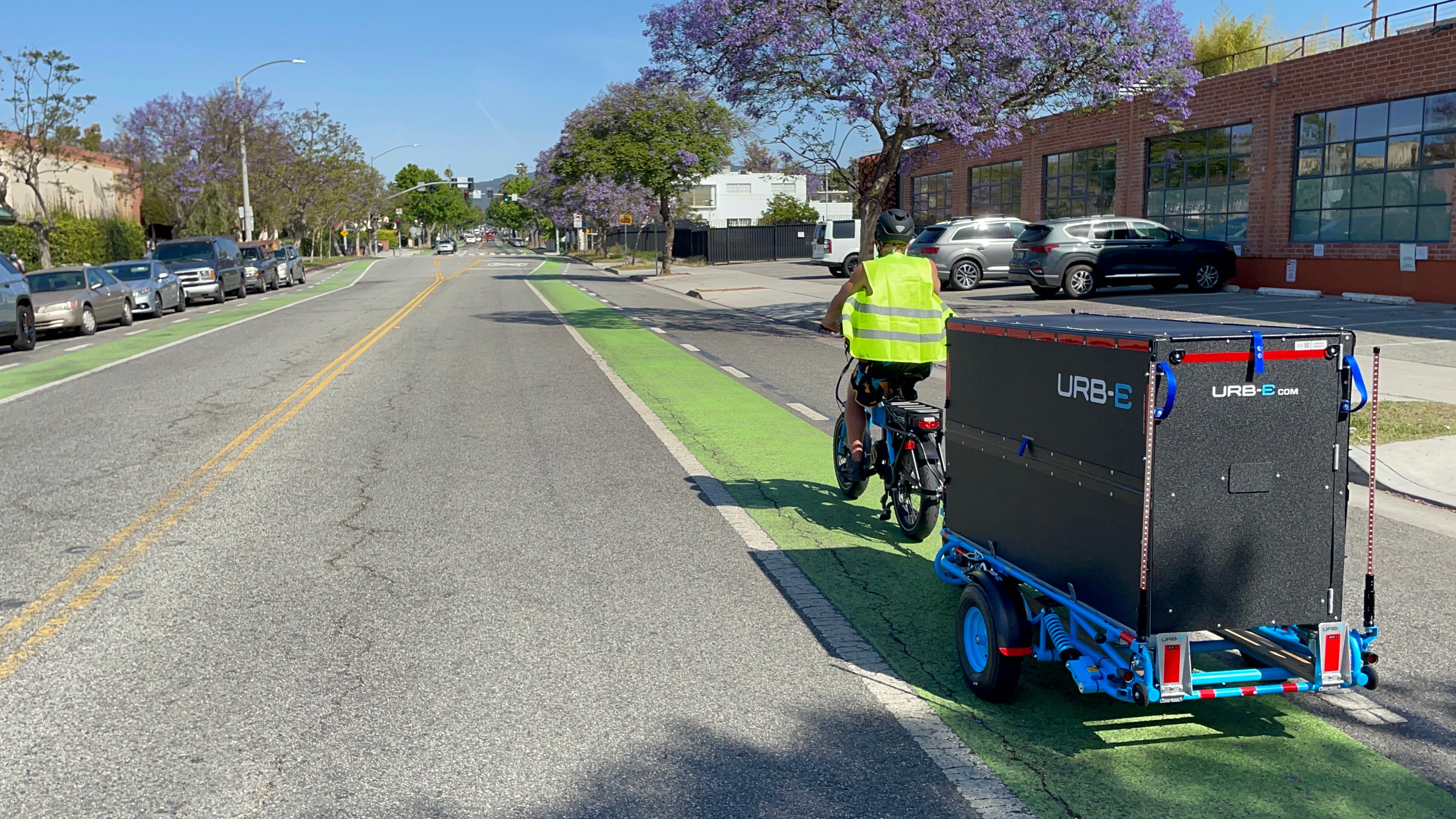 An Urb-E delivery driver travels down a Santa Monica street with his electric cargo bike