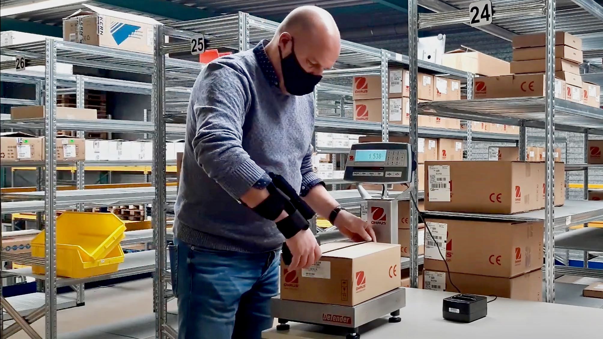 A man measures a box using a Cubetape