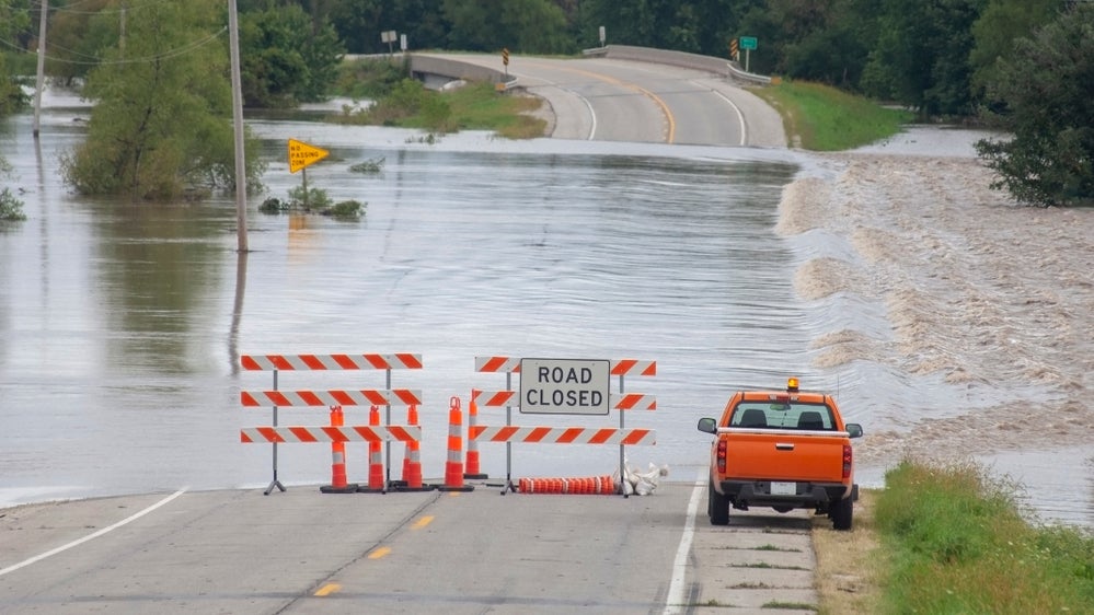 Barricade blocking flooded road.