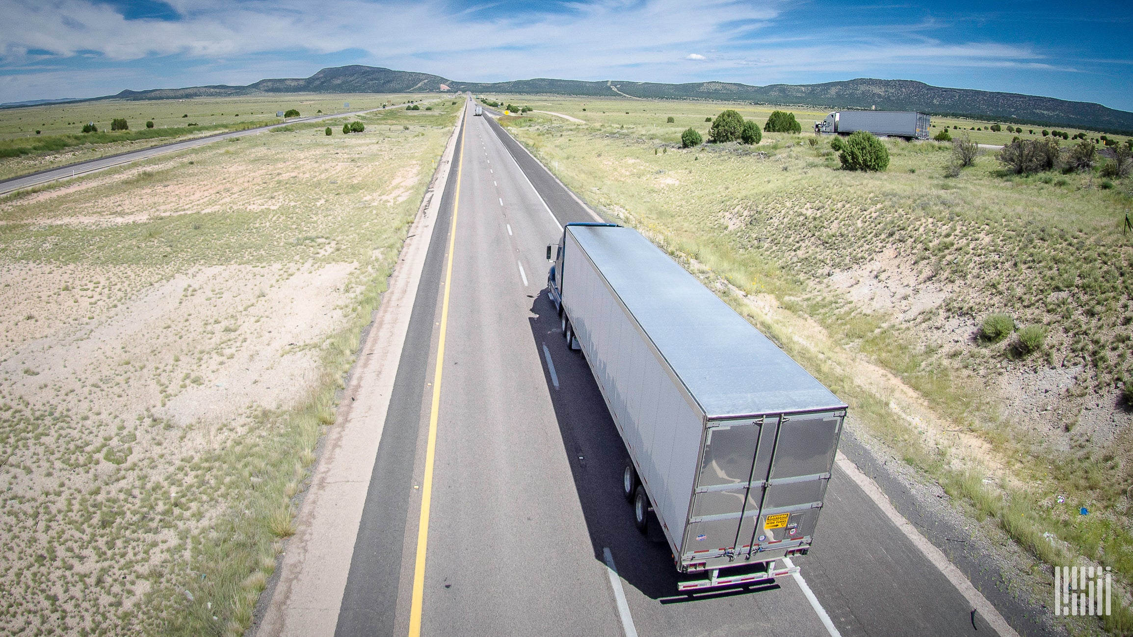 overhead image of tractor-trailer truck on highway