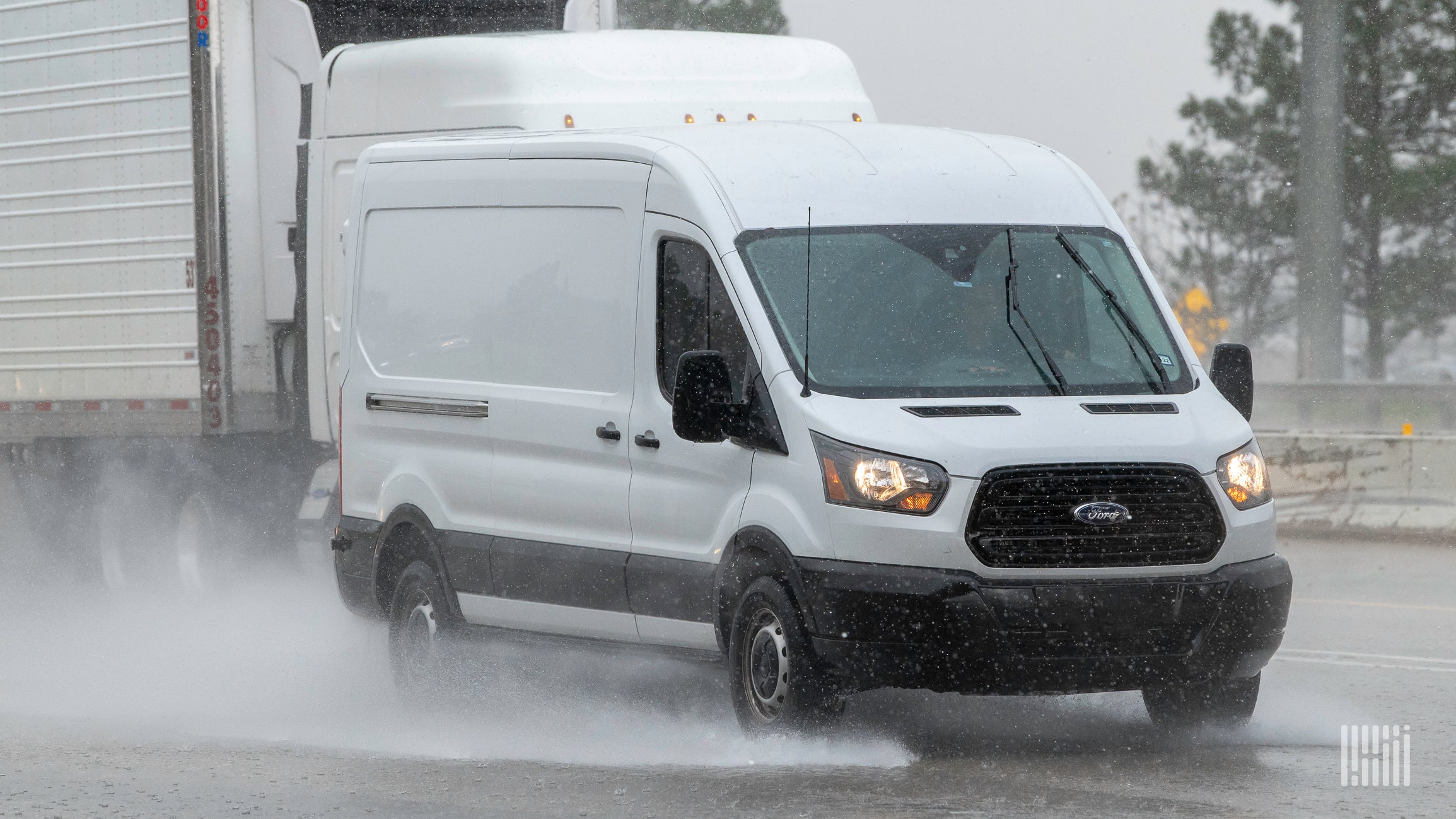 A sprinter van on the highway during heavy rain