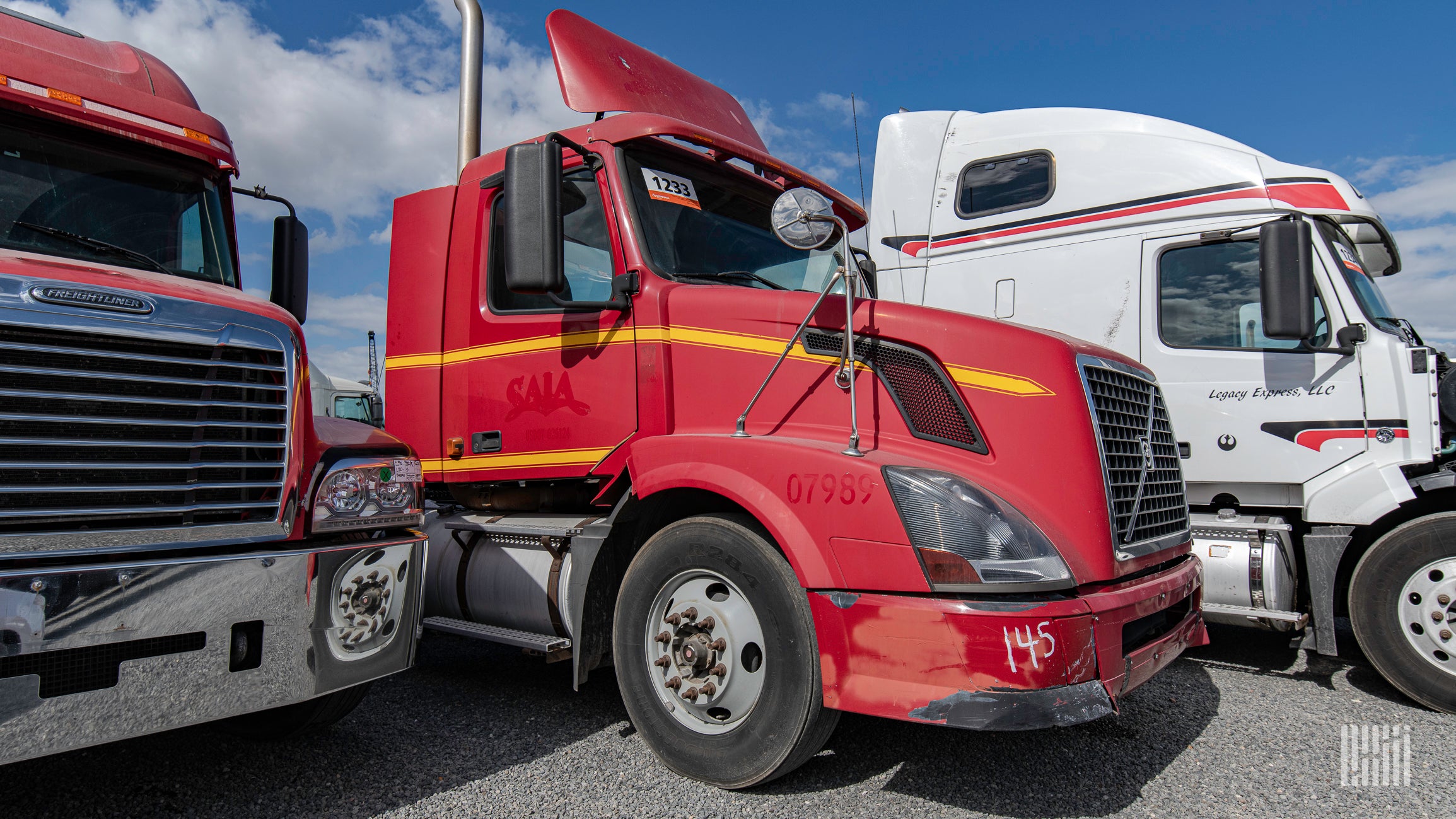 three used trucks at a Ritchie Bros. auction in Houston