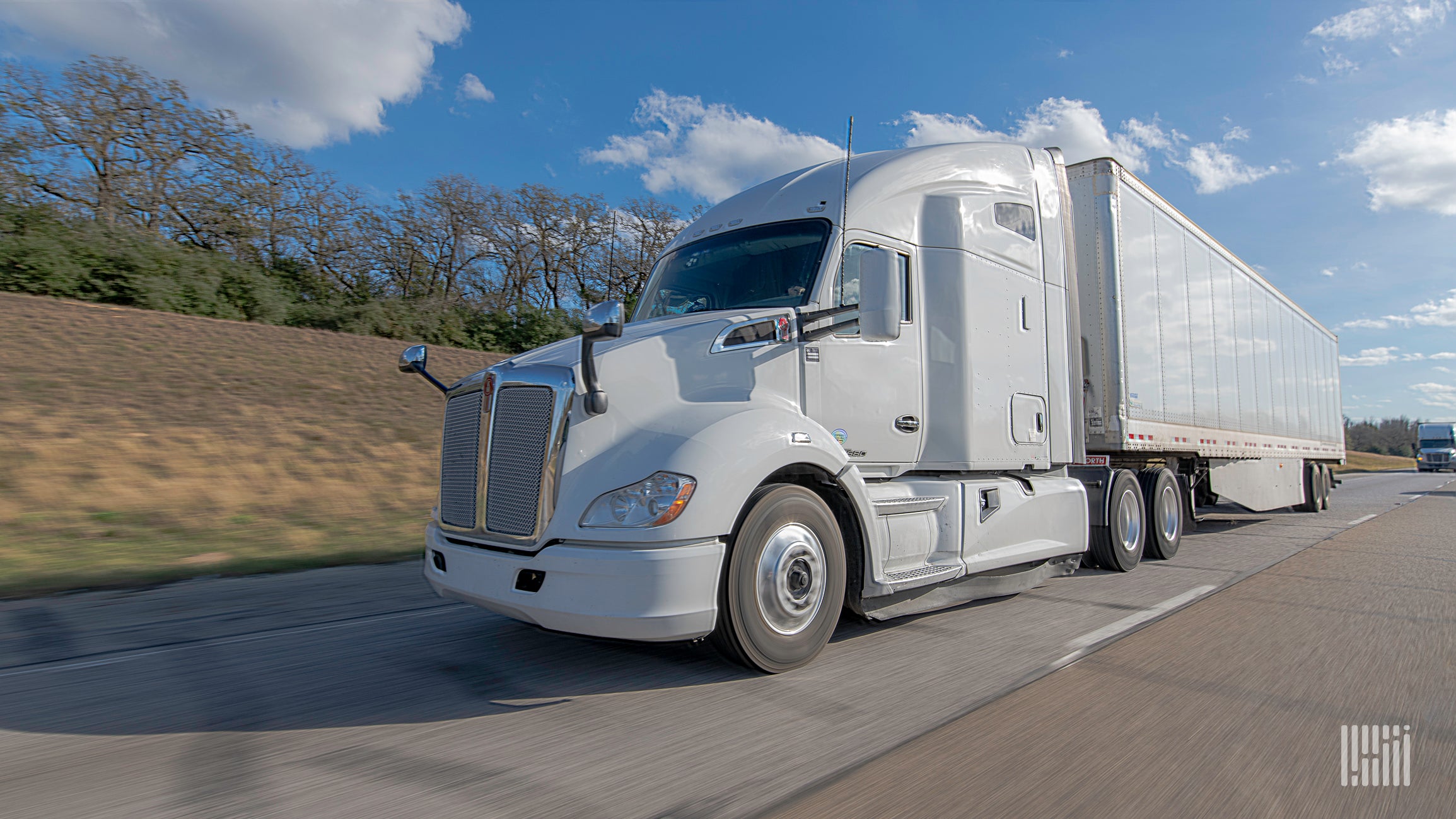 A white truck pulling a white trailer