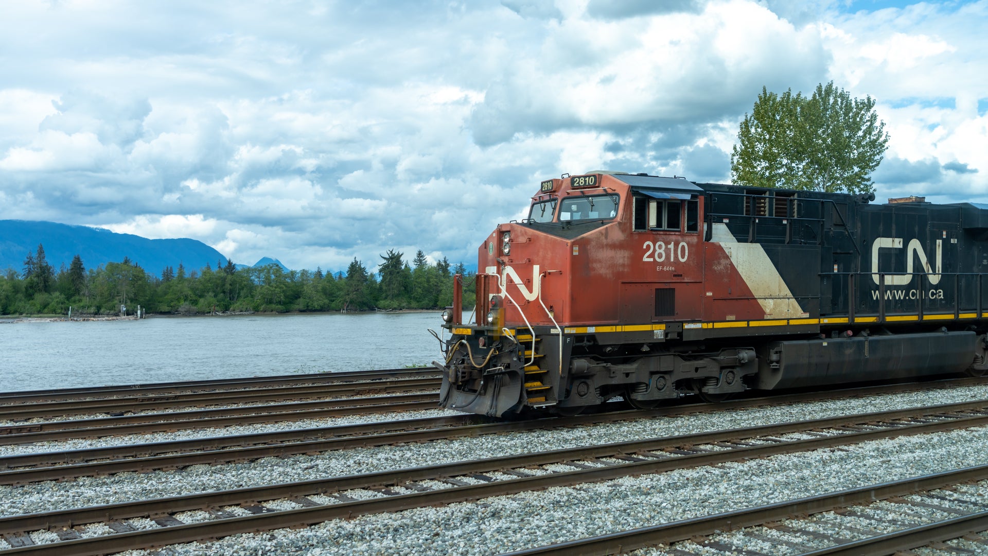 A CN train is operating next to a lake.