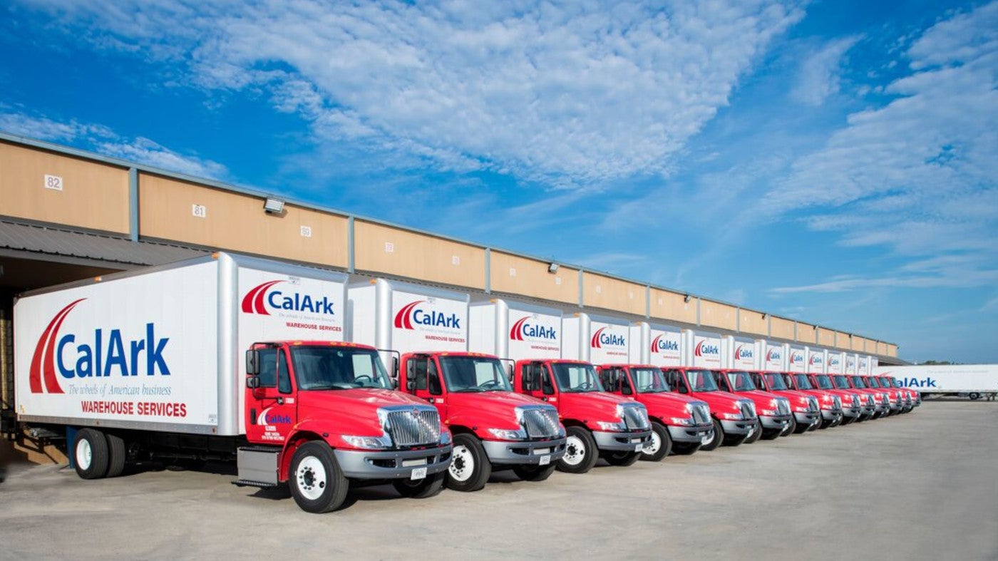 Row of CalArk box trucks at warehouse