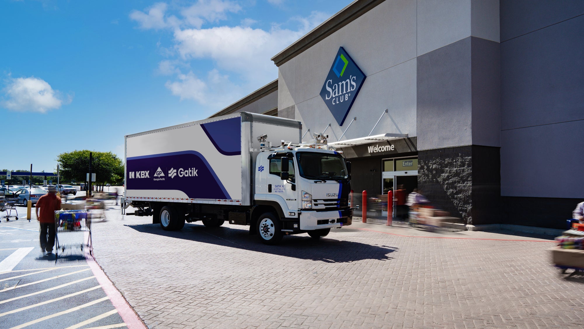 White and purple box truck parked in front of Sam's Club store entrance