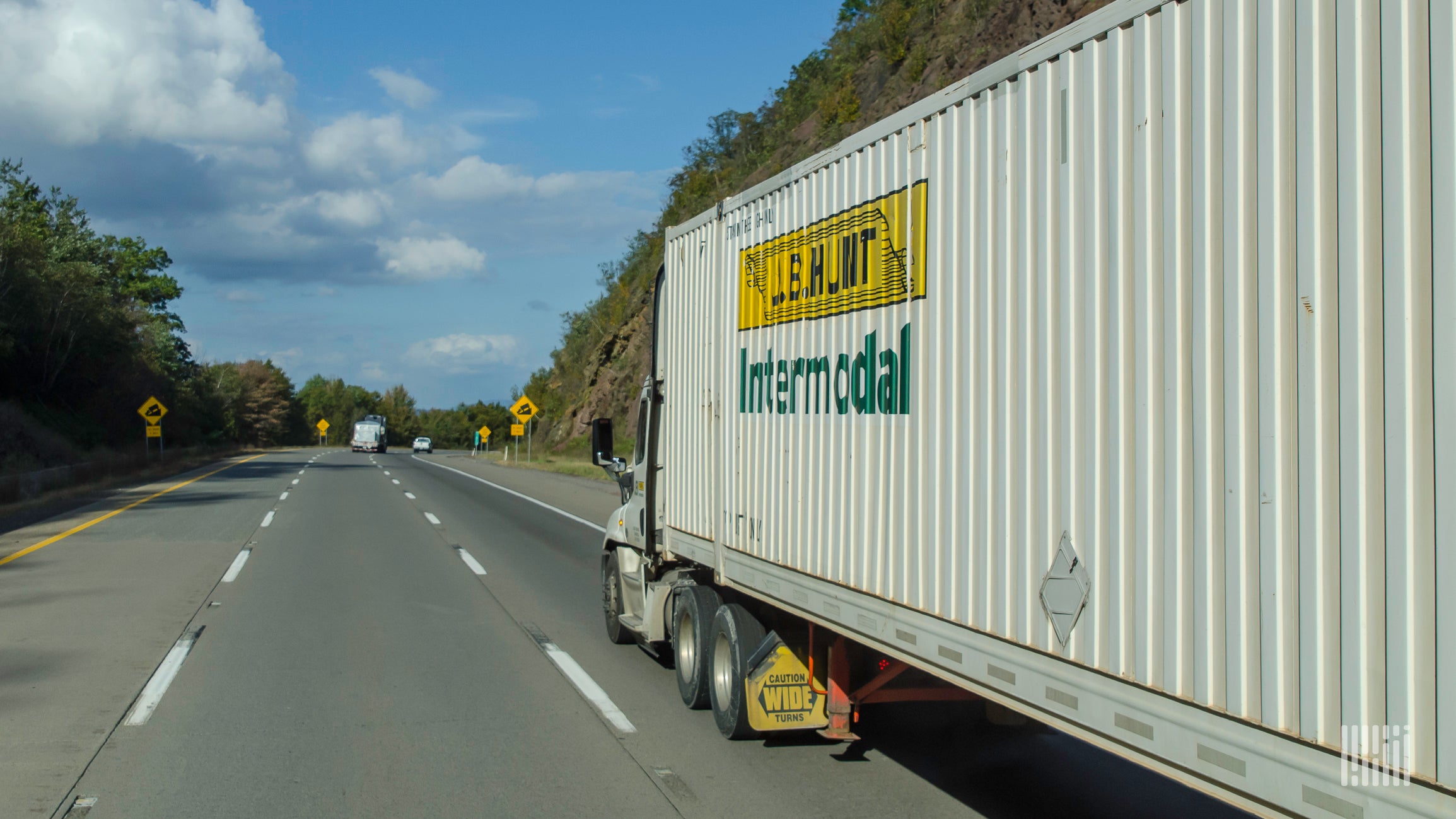 A tractor hauling a J.B. Hunt intermodal trailer