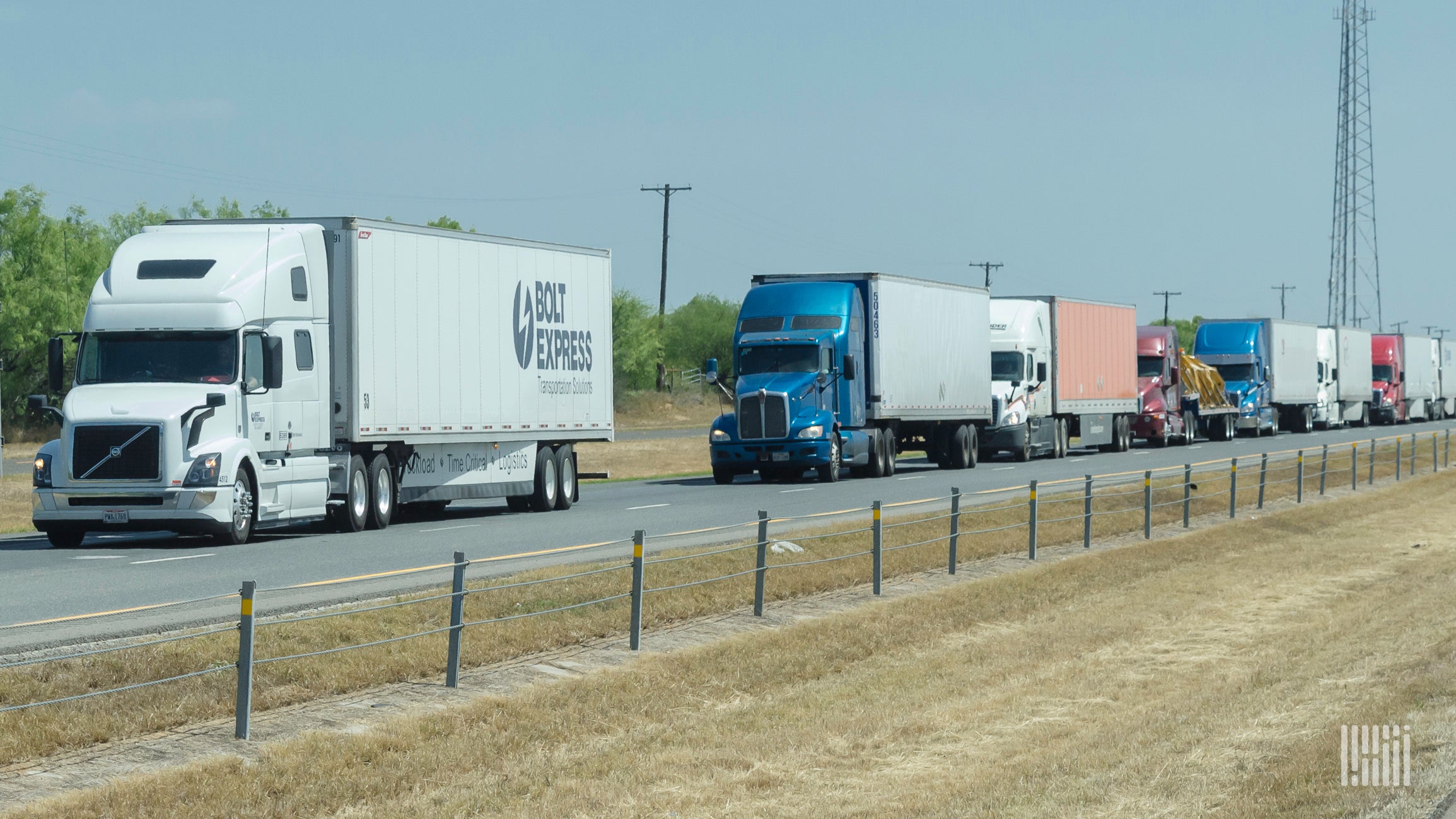 Row of trucks along a stretch of highway