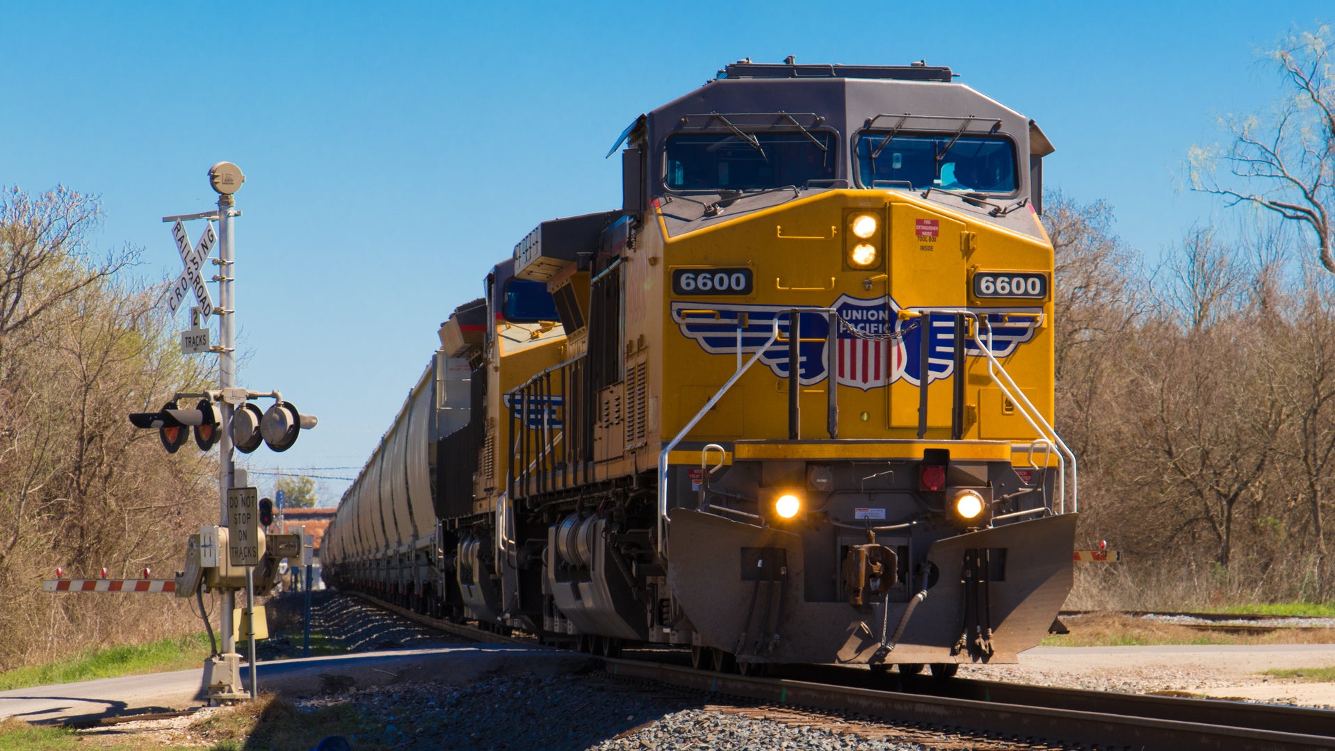 A Union Pacific locomotive passes through a railroad crossing.