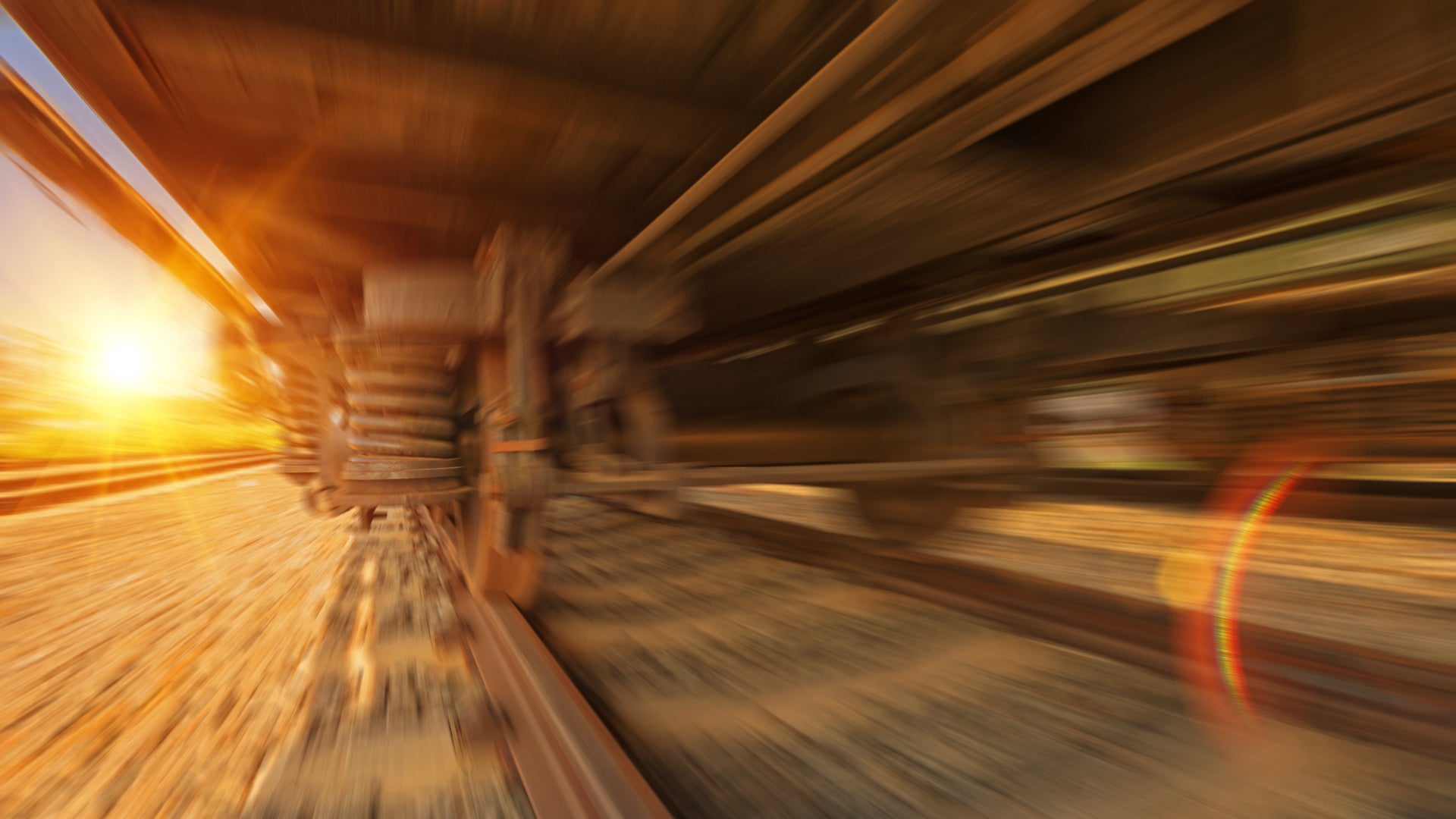 A close-up of train wheels running on track track.