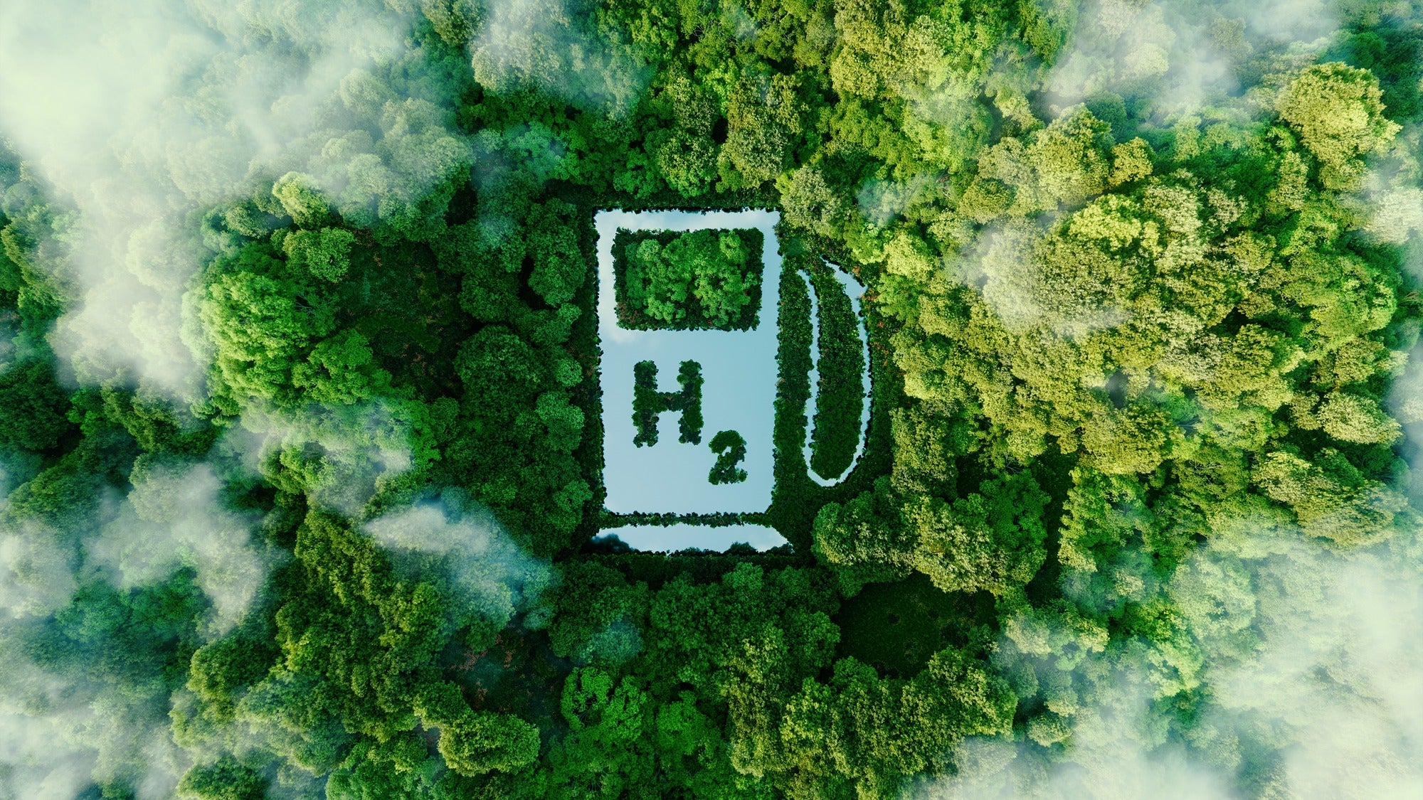 A lake in the shape of a hydrogen pump is surrounded by green trees.