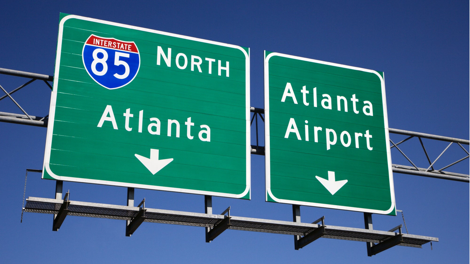 Highway sign indicating direction to Atlanta and Atlanta airport