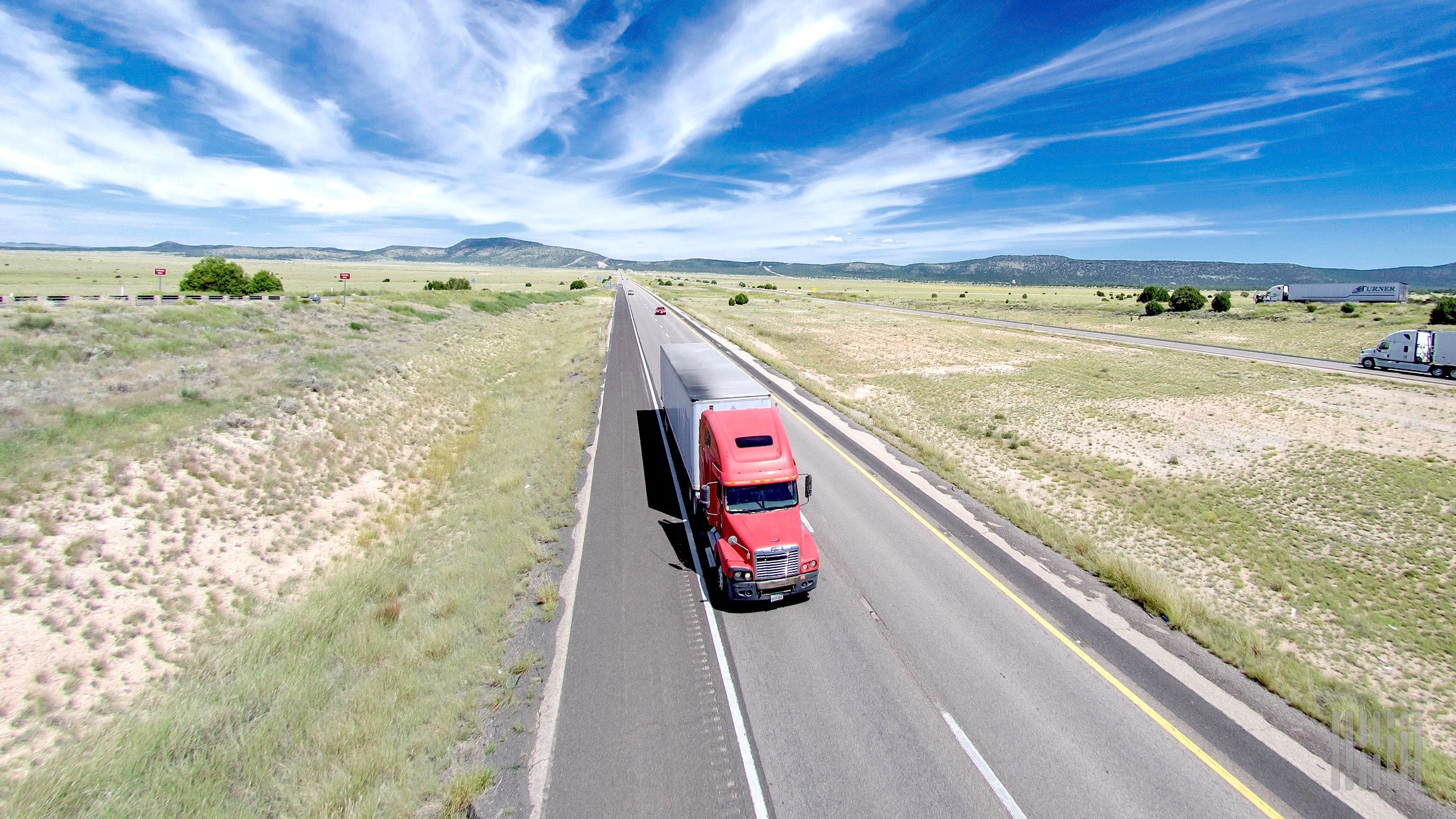 A truck rolls down the highway.