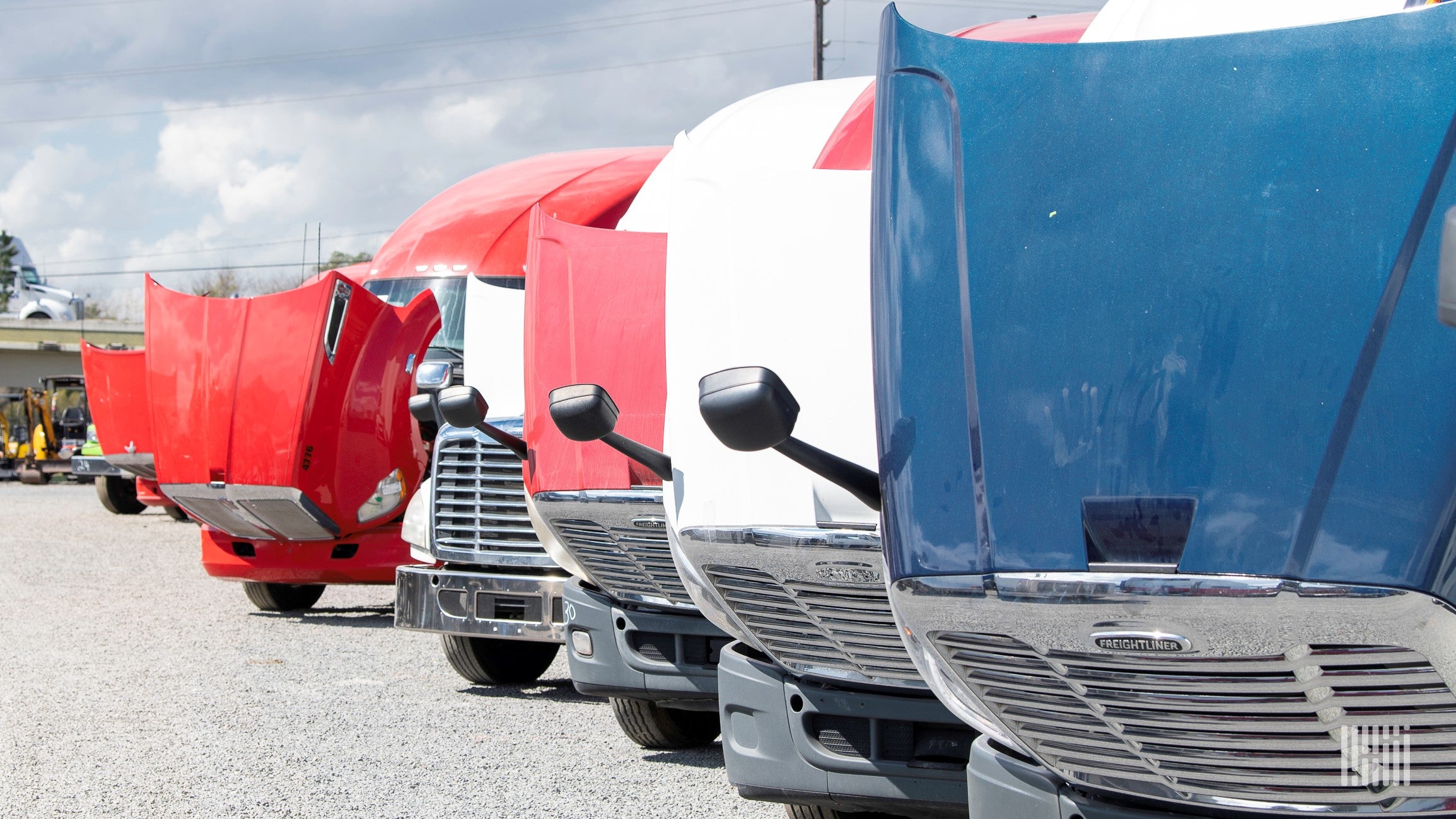 Row of trucks with hoods open