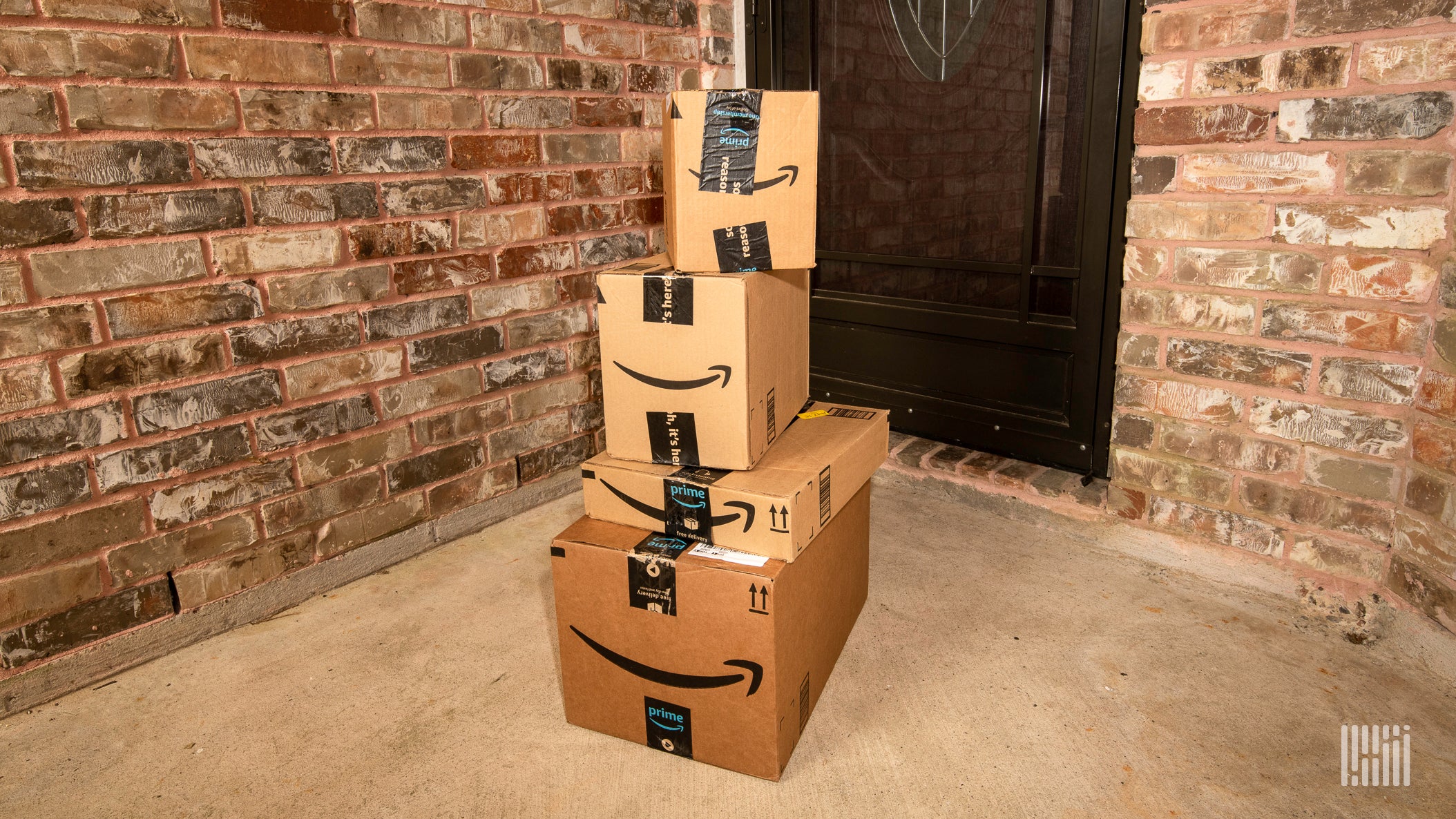 pile of Amazon boxes on front porch