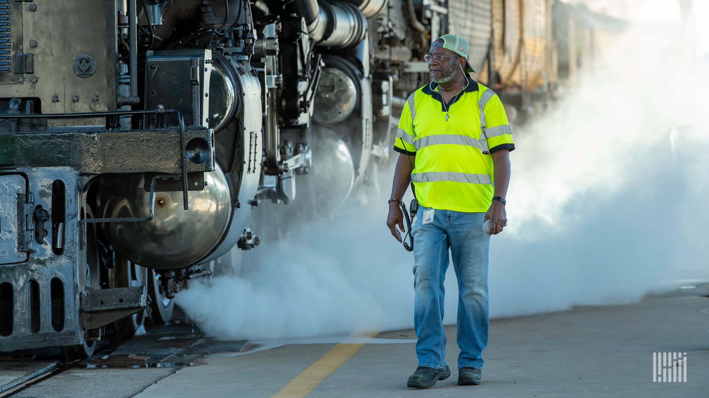 Rail crew worker standing next to train