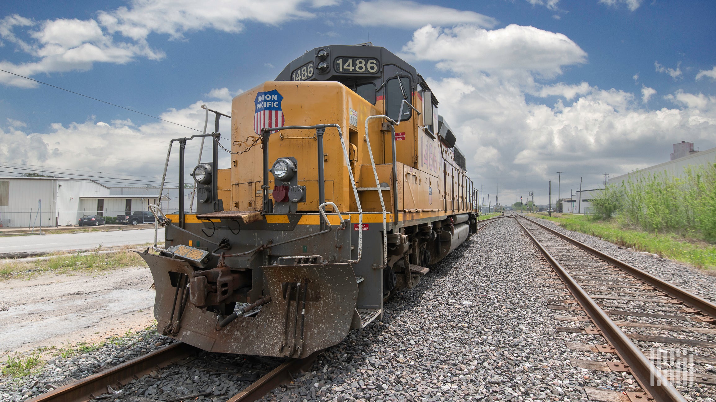 A locomotive sits on train track.