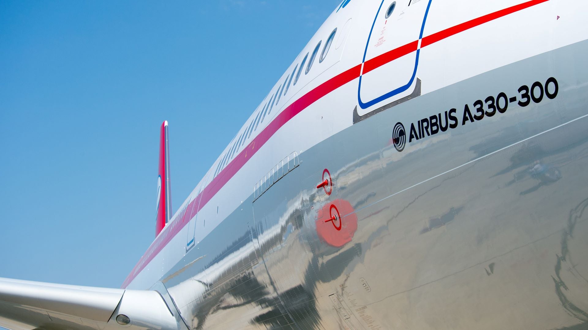 Close up of fuselage of an A330-300 aircraft near the cockpit.