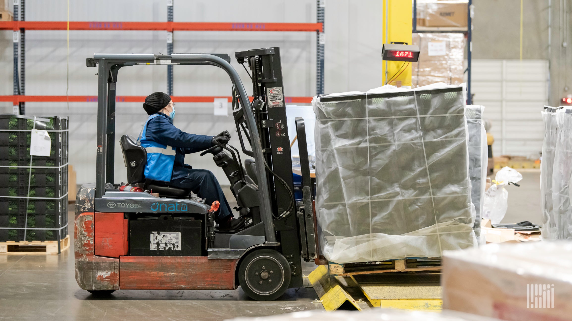 Forklift moving pallets in warehouse