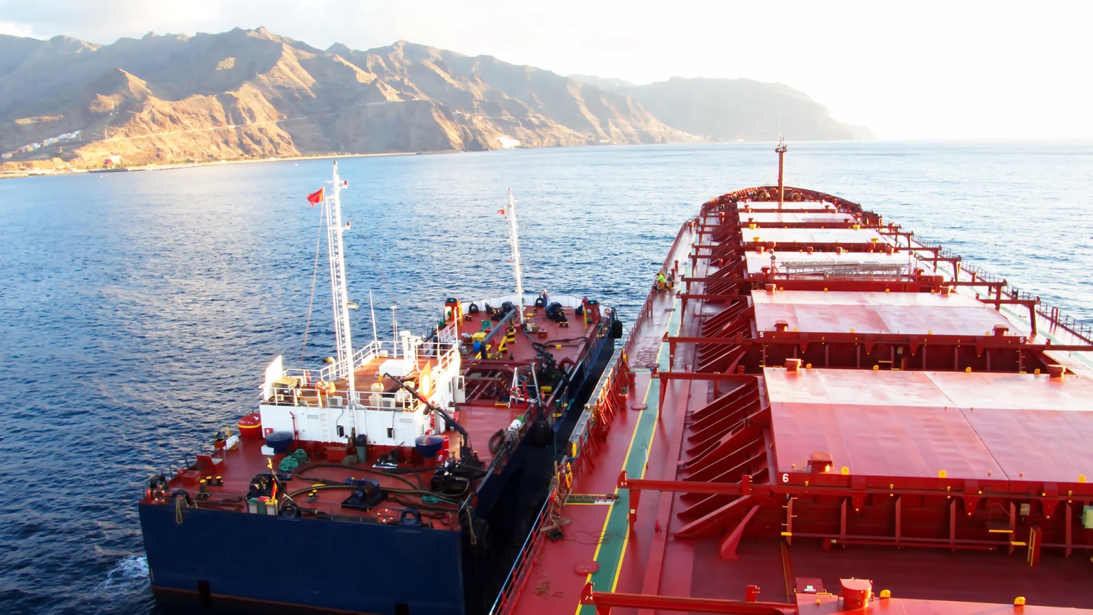 photo of a bunker tanker refueling a bulk ship