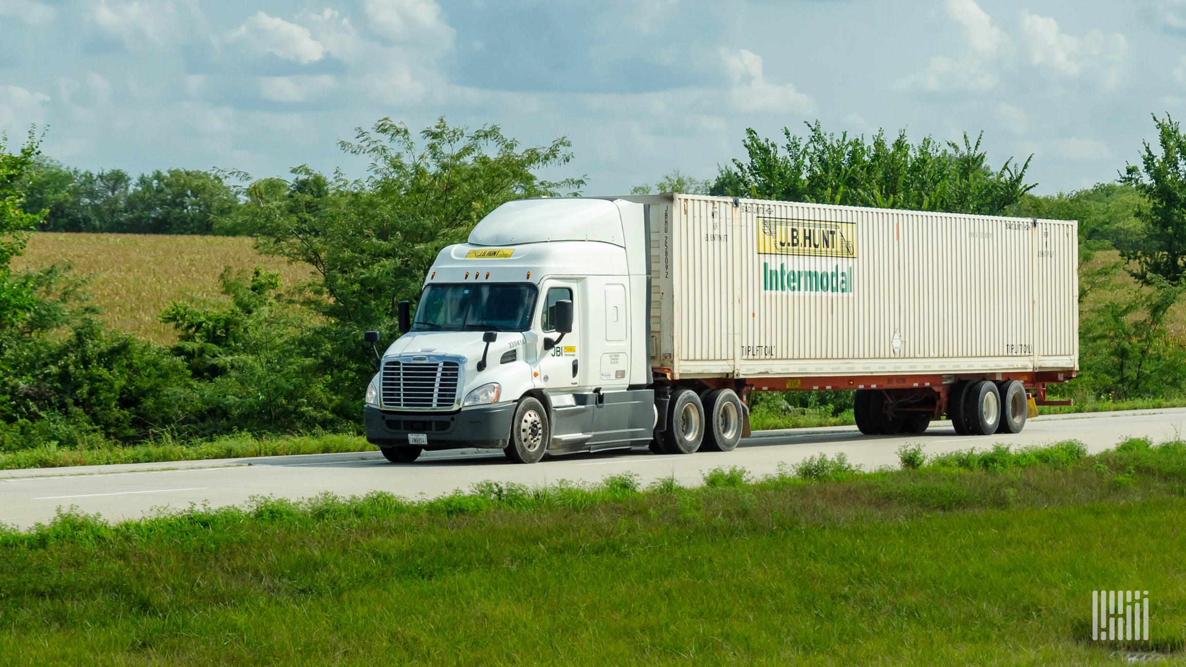 A J.B. Hunt tractor pulling a J.B. Hunt intermodal container