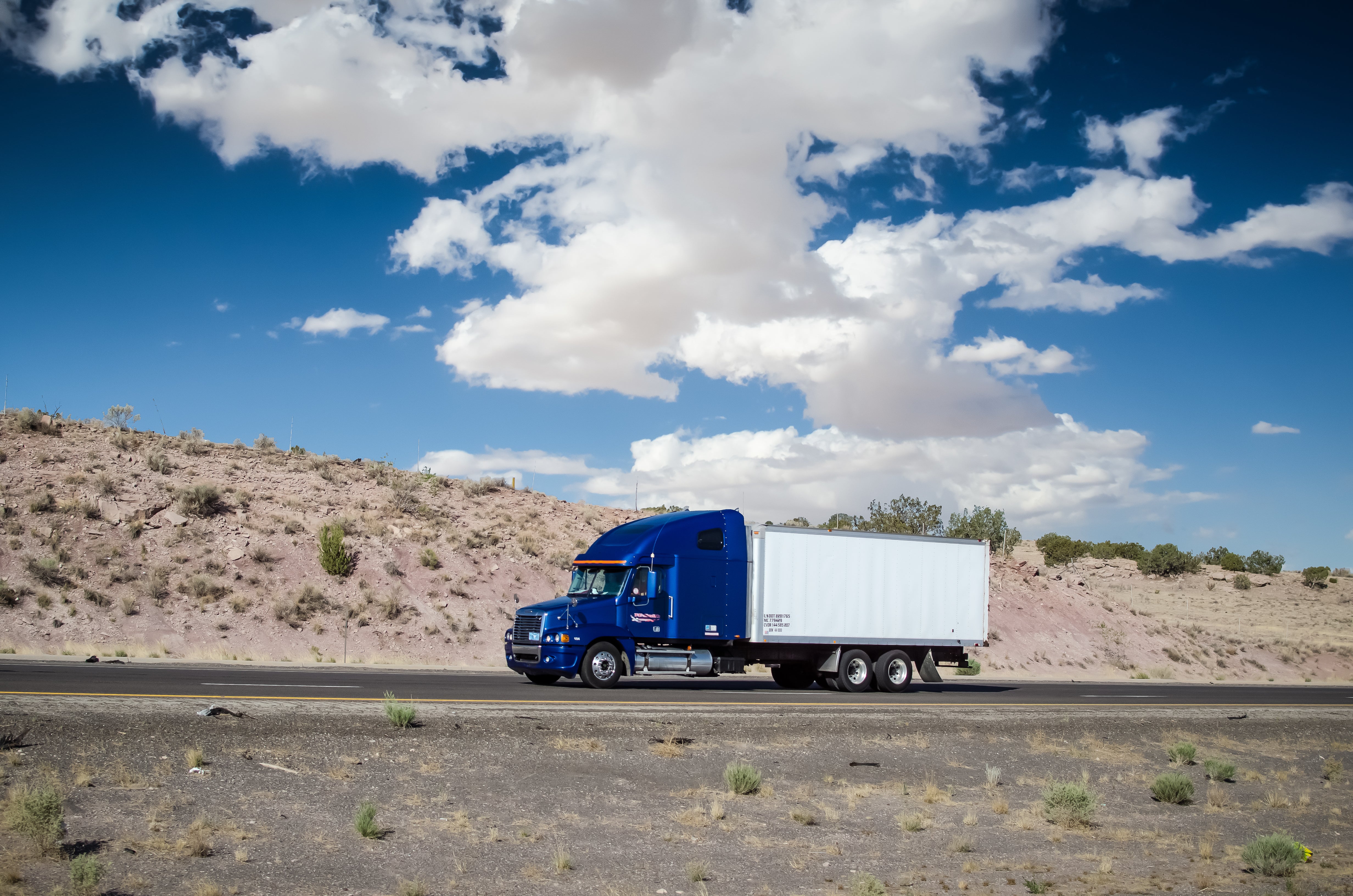 box truck driving past mountains