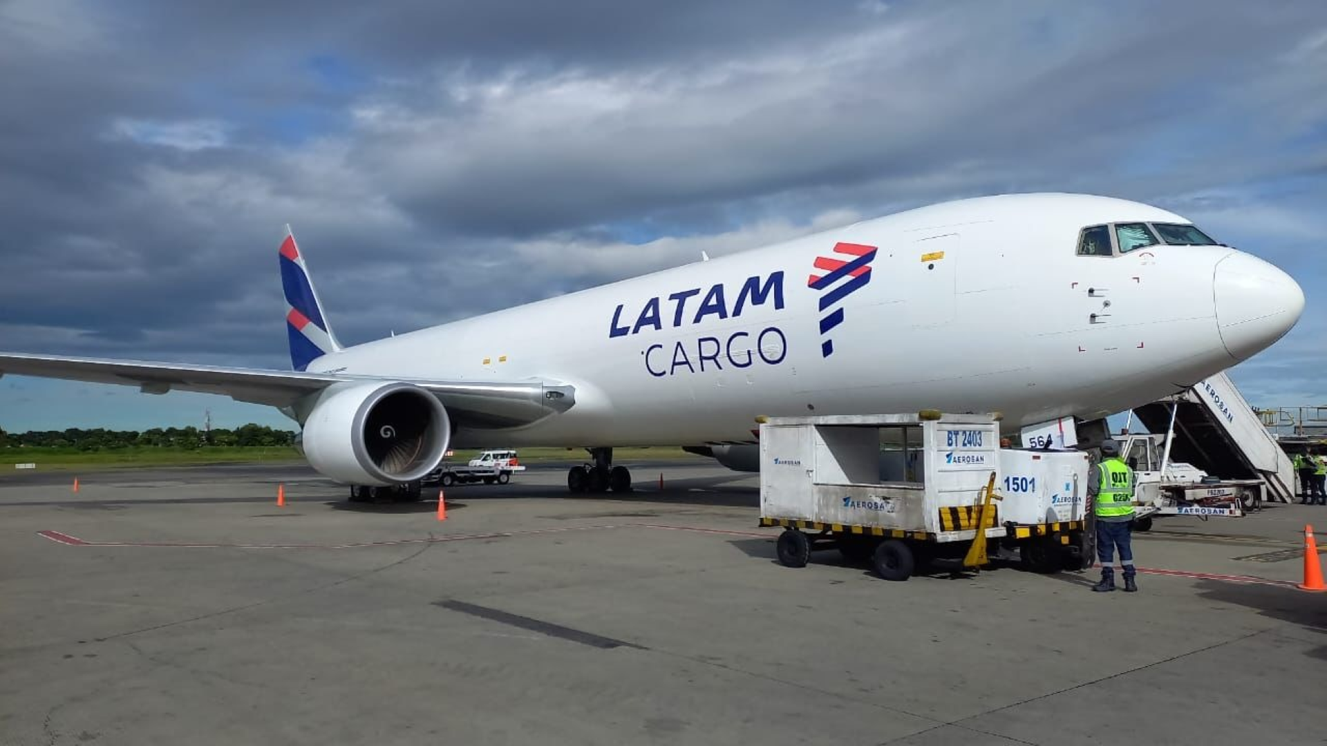 A LATAM Cargo jet, with blue lettering, sits on the tarmac.