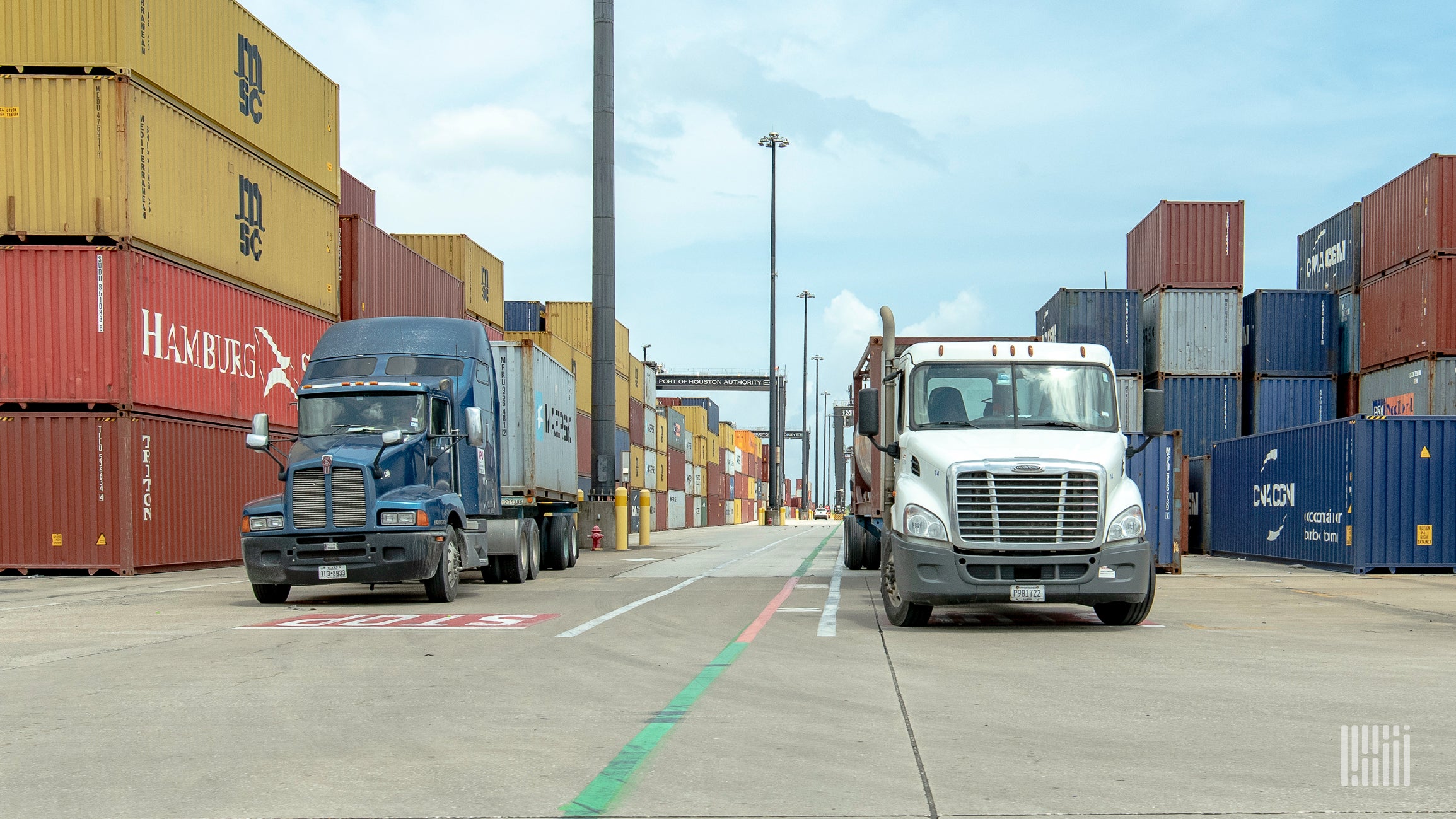 trucks moving containers at marine port.