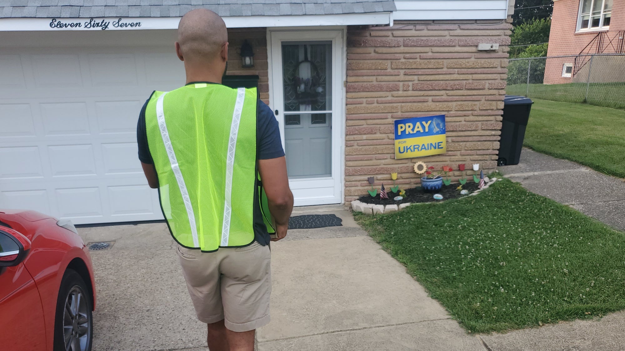 Delivery driver approaches a front door to leave a package