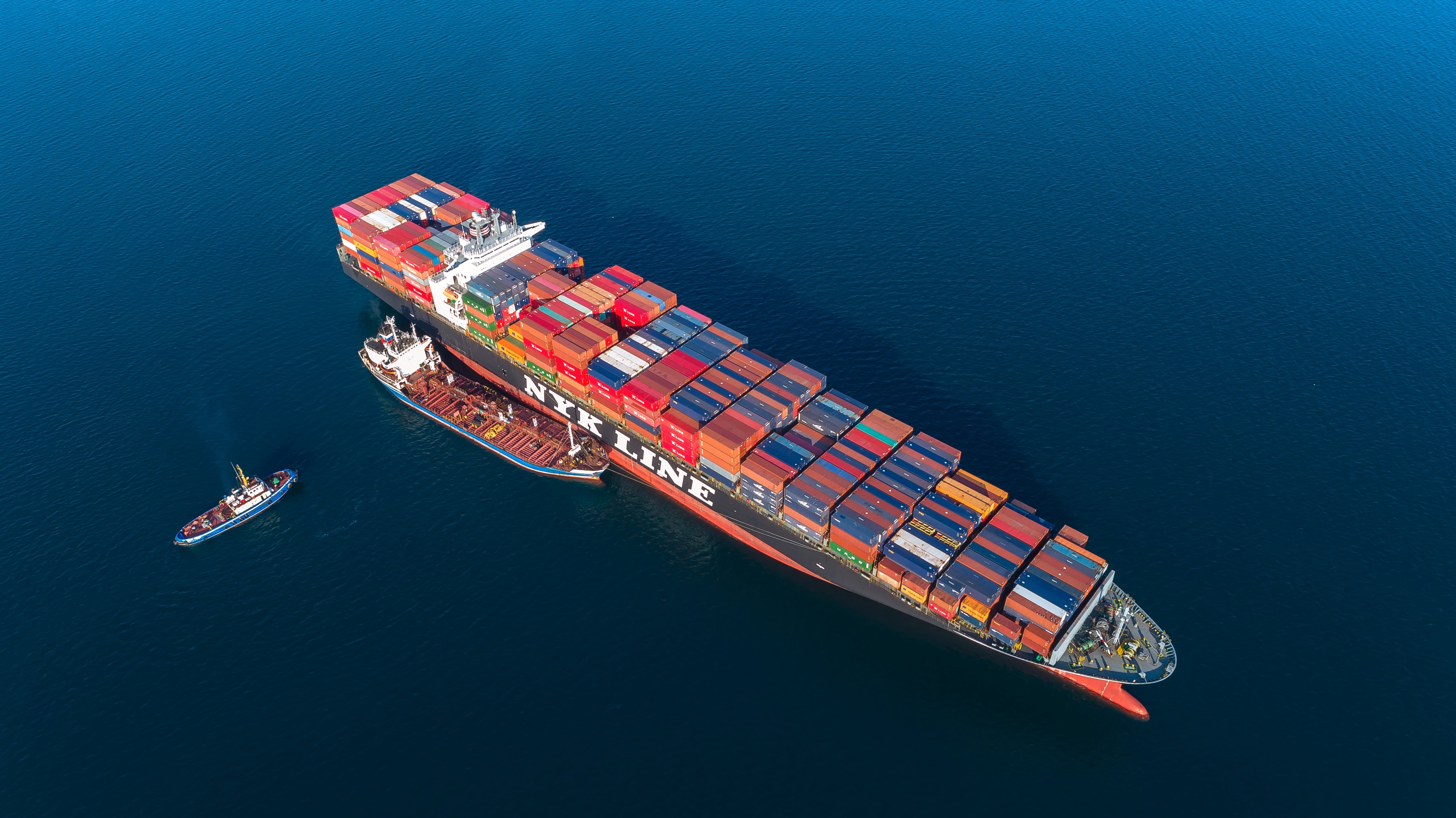 photo of a container ship getting fuel