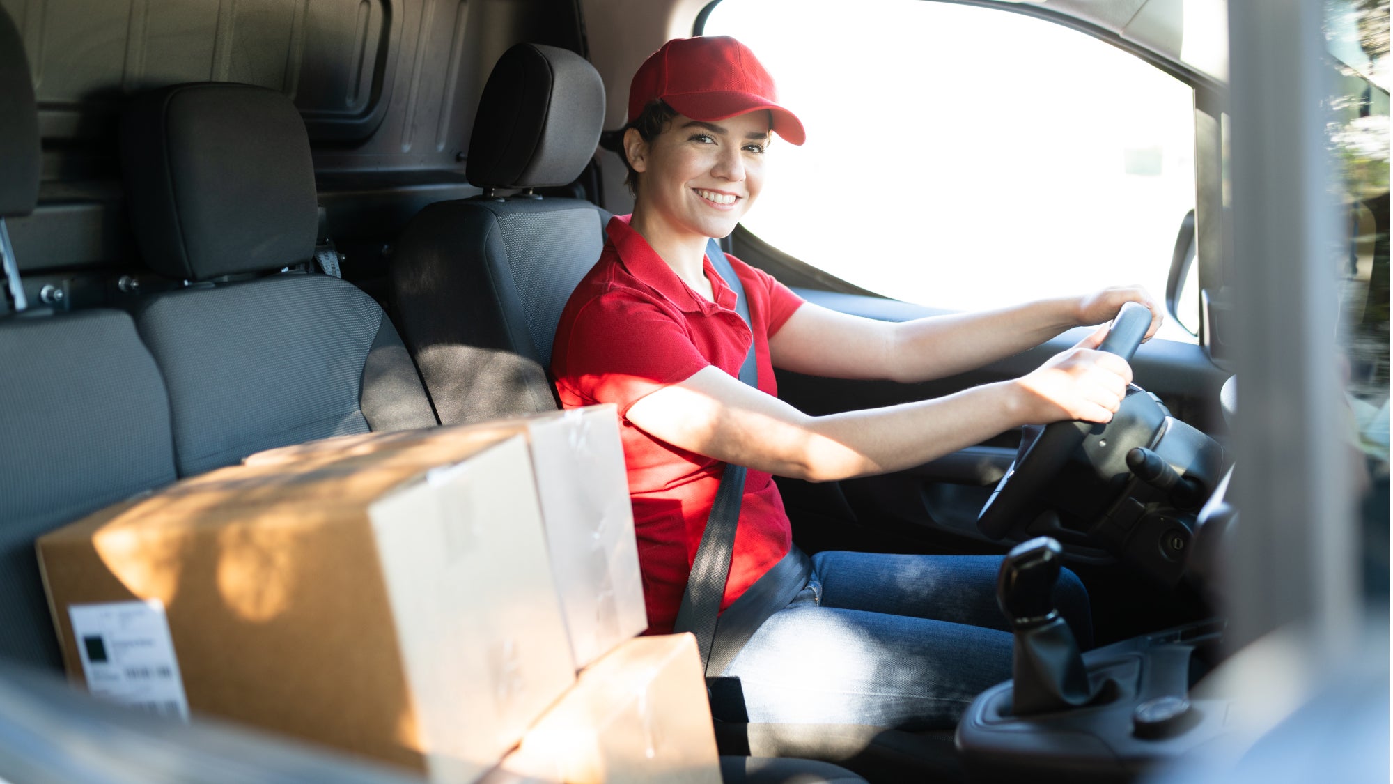 Woman in delivery van with boxes