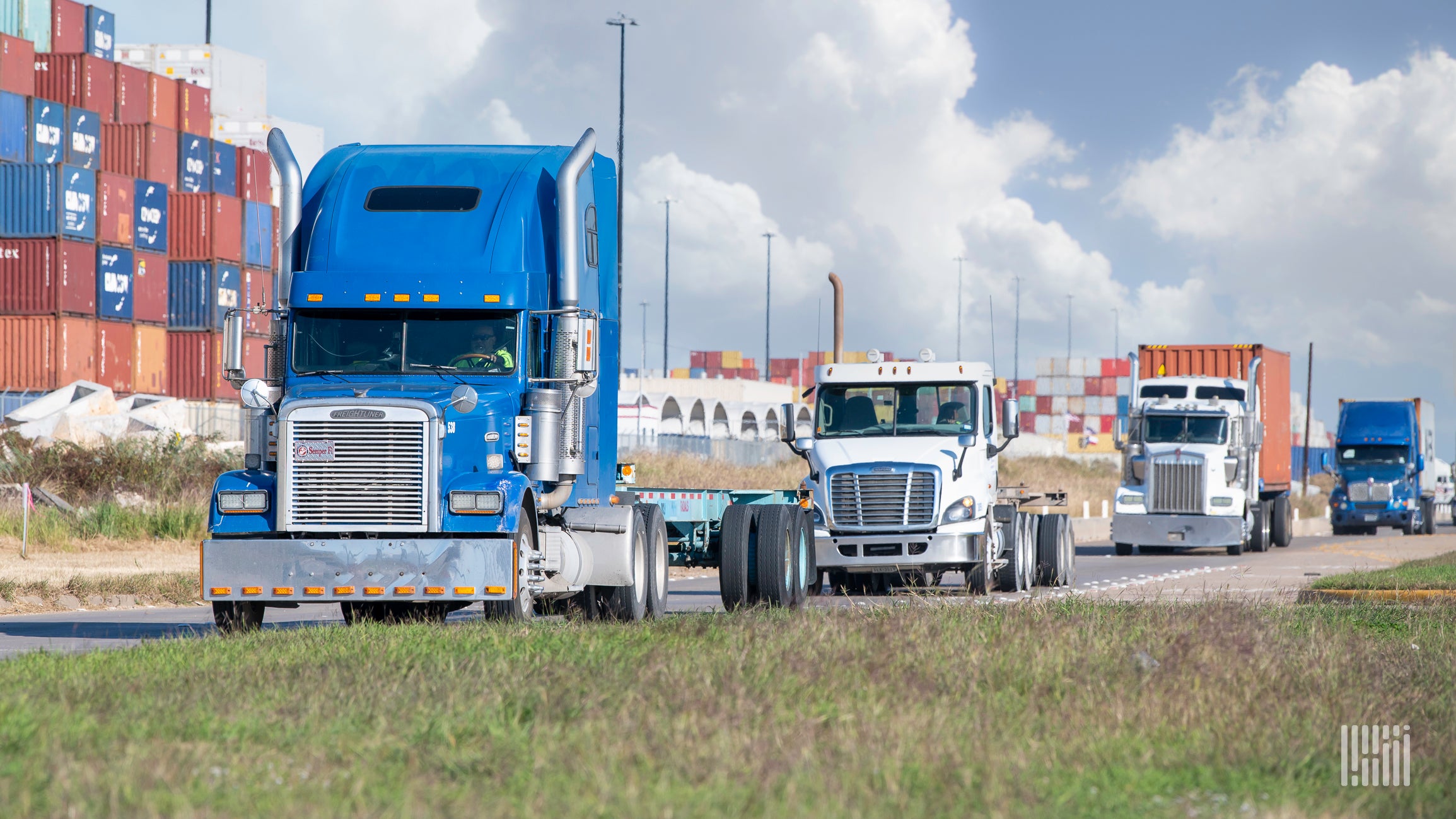 Multiple drayage trucks at a port